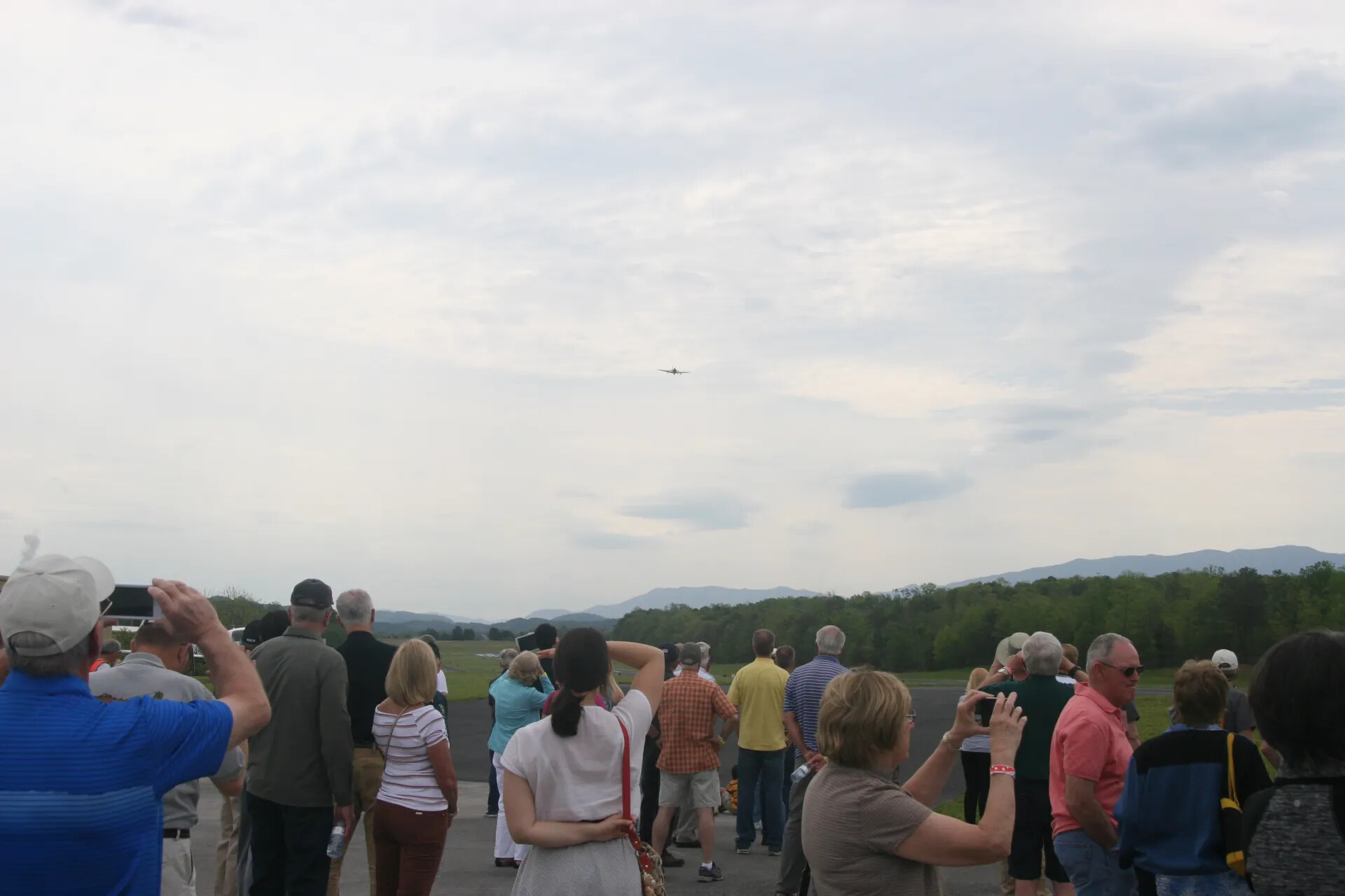 Crowd Watches Aircraft Flyover at Tailwind Commemorative Event