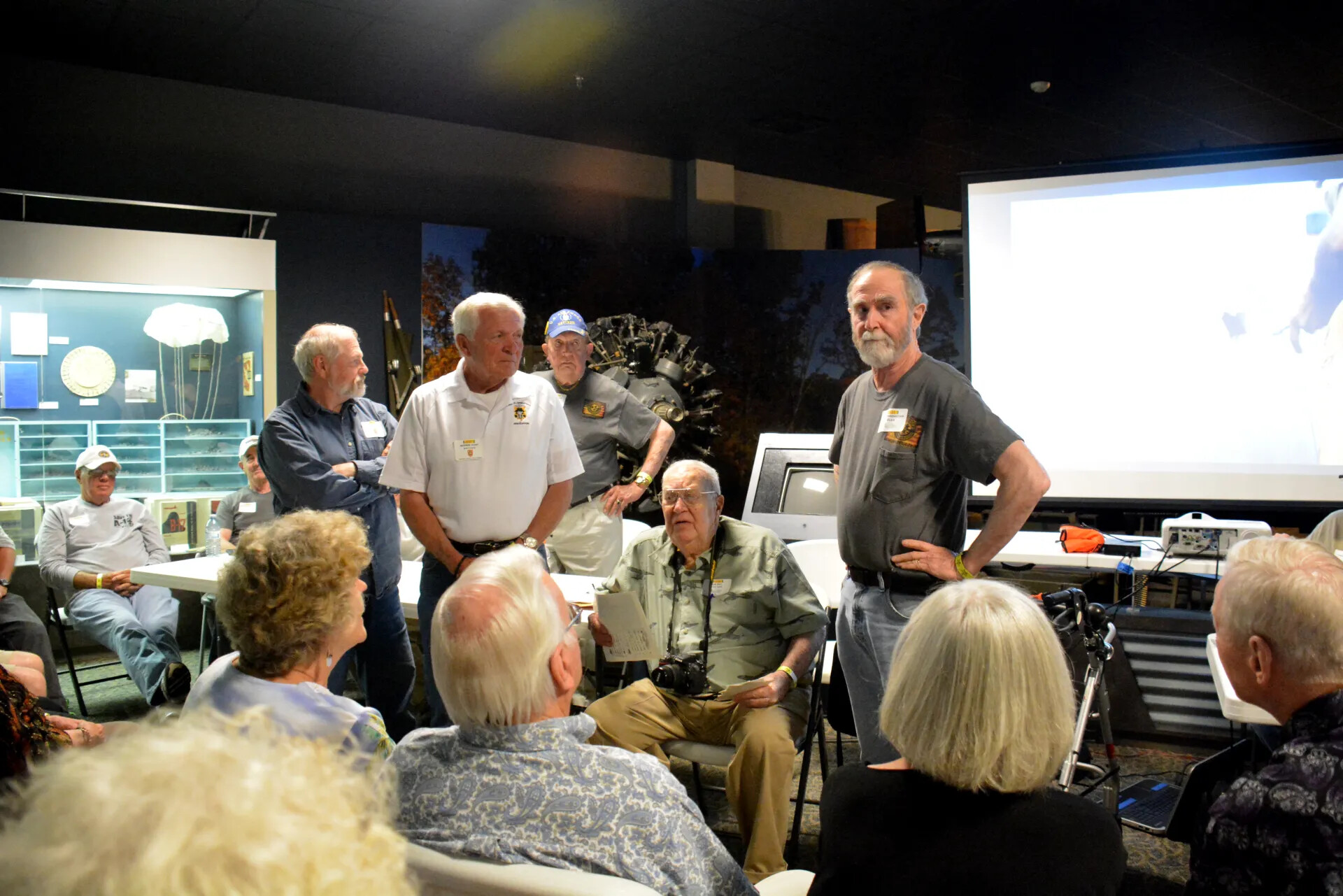 Veterans' Reunion Meeting, Aviation Museum — Close Group Portrait During Informal Discussion