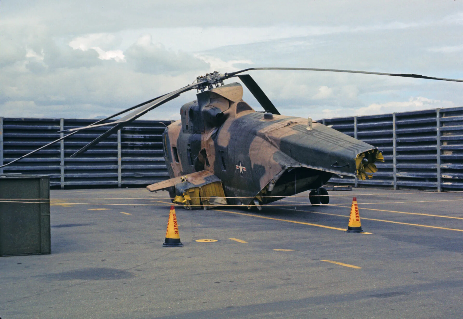 Wrecked Sikorsky HH-3 Helicopter with Crumpled Nose and Severed Tail Section on Flight Deck