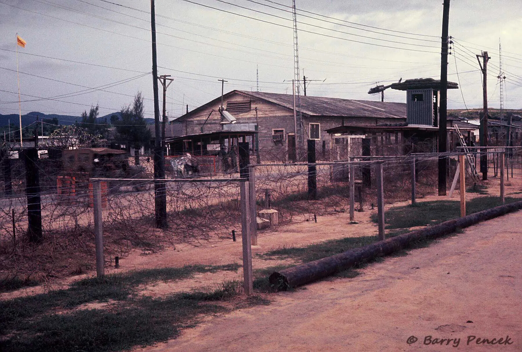 Fortified Base Camp Perimeter with Guard Tower and South Vietnamese Flag