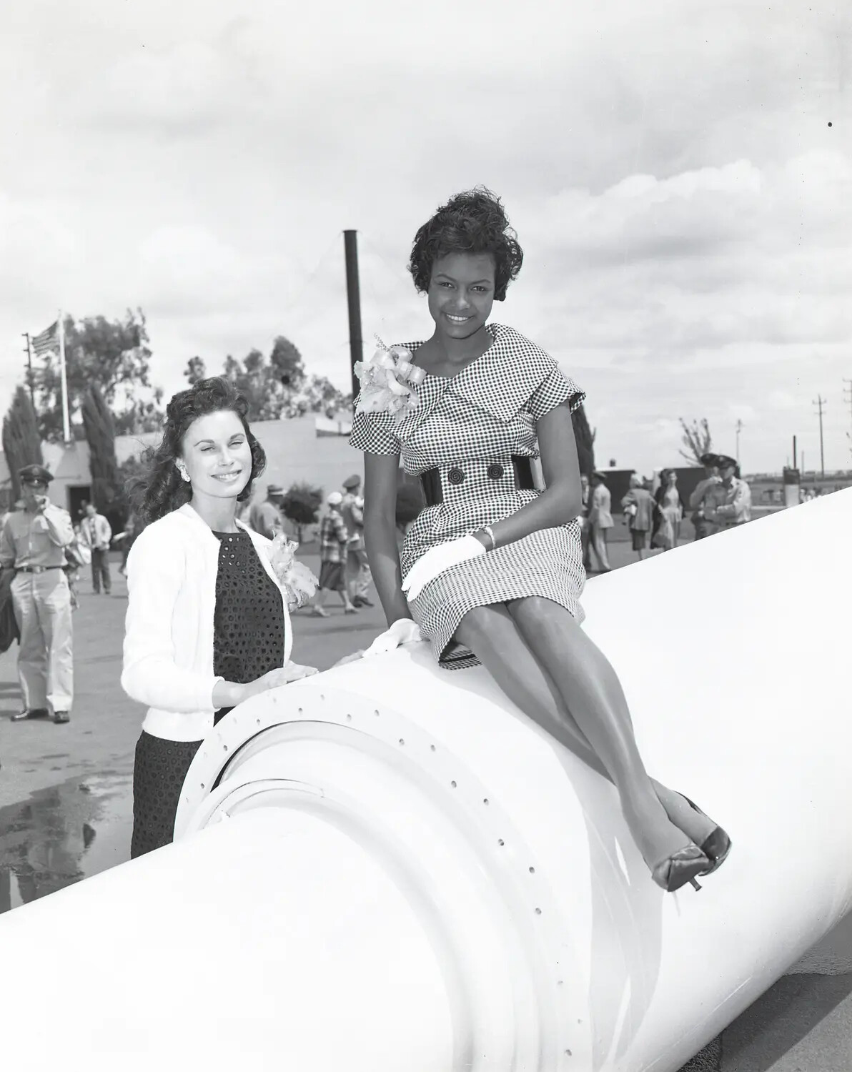 Woman Seated on Large Rocket Motor Casing with Companion, Public Open House Event, Early 1960s