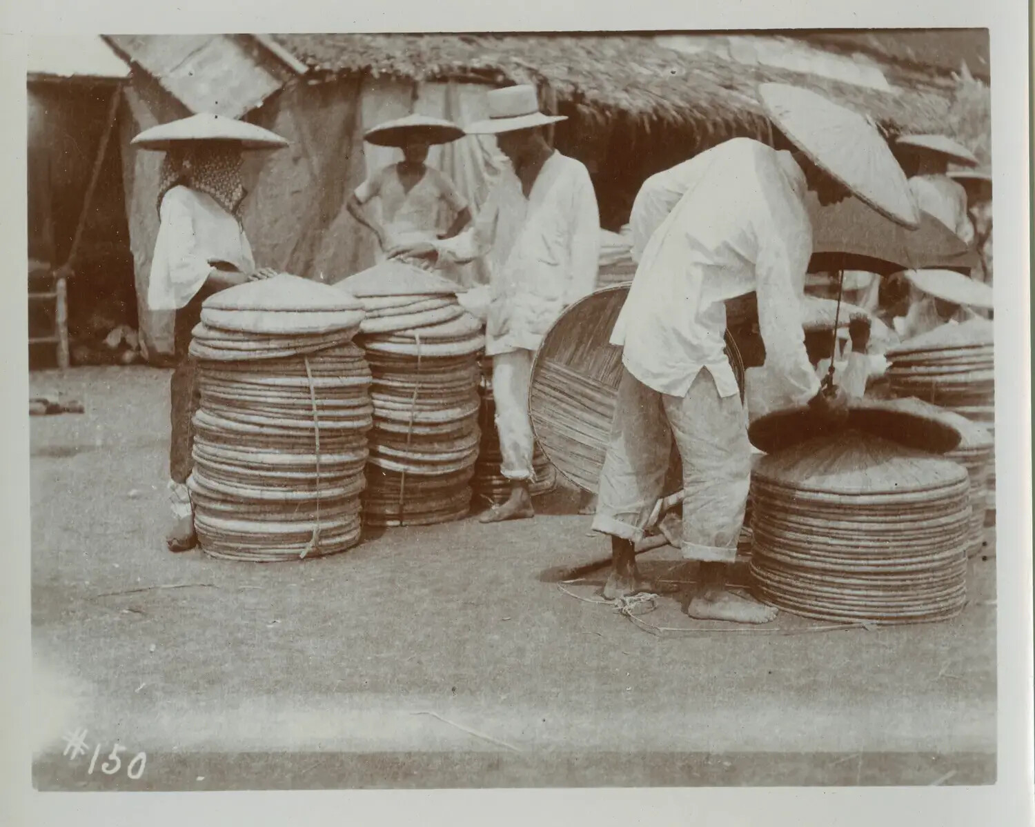 Vendors and Stacked Woven Hats at a Philippine Marketplace, c. 1890s