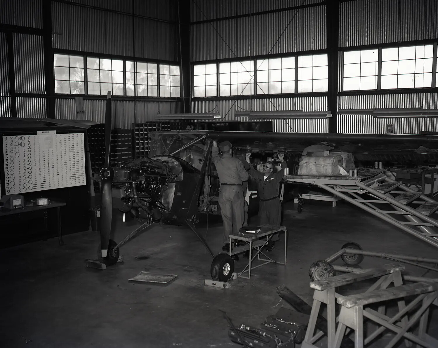California Army National Guard Mechanics Working on Cessna L-19 Bird Dog Wing Structure, Sacramento Hangar