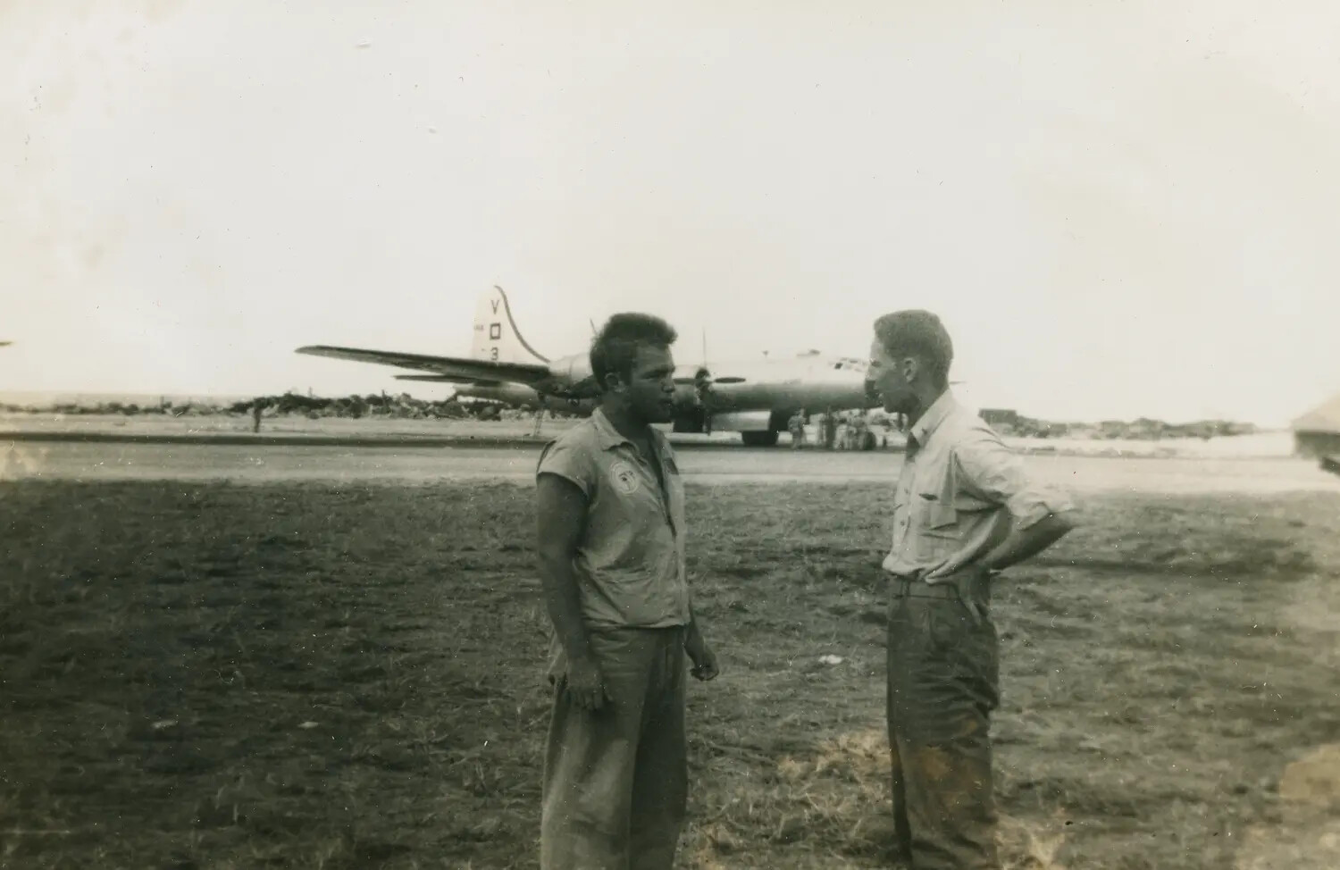 Airmen Conversing on the Flight Line Beside a B-29 Superfortress, Pacific Theater, WWII