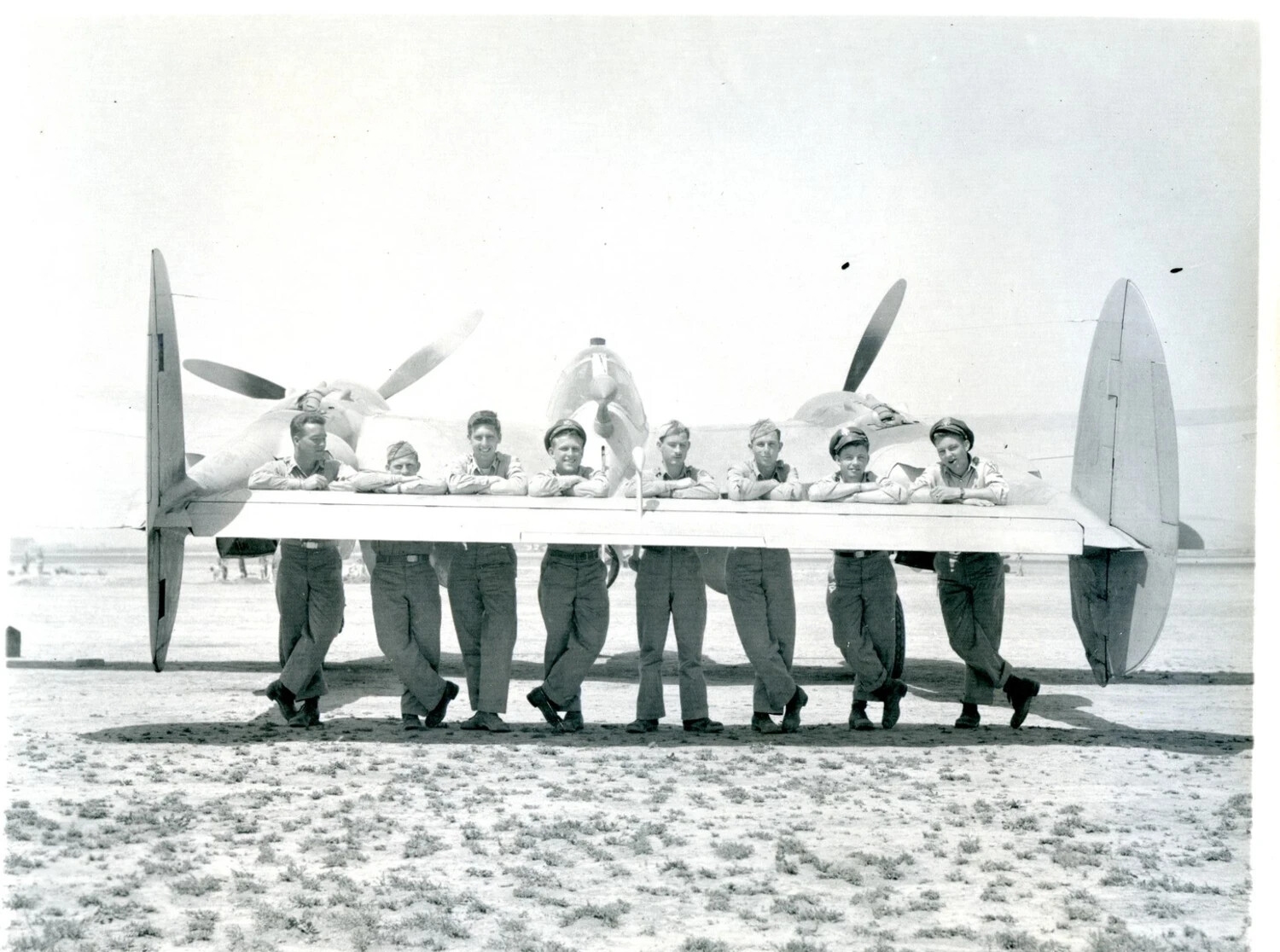 Ground Crew Posing on P-38 Lightning Wing, WWII Airbase