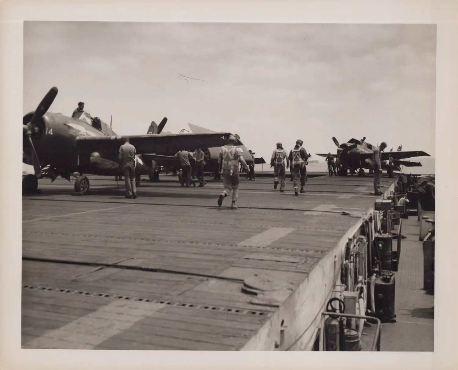 Pilots and FM-2 Wildcat Fighters on Flight Deck, USS Petrof Bay (CVE-80)
