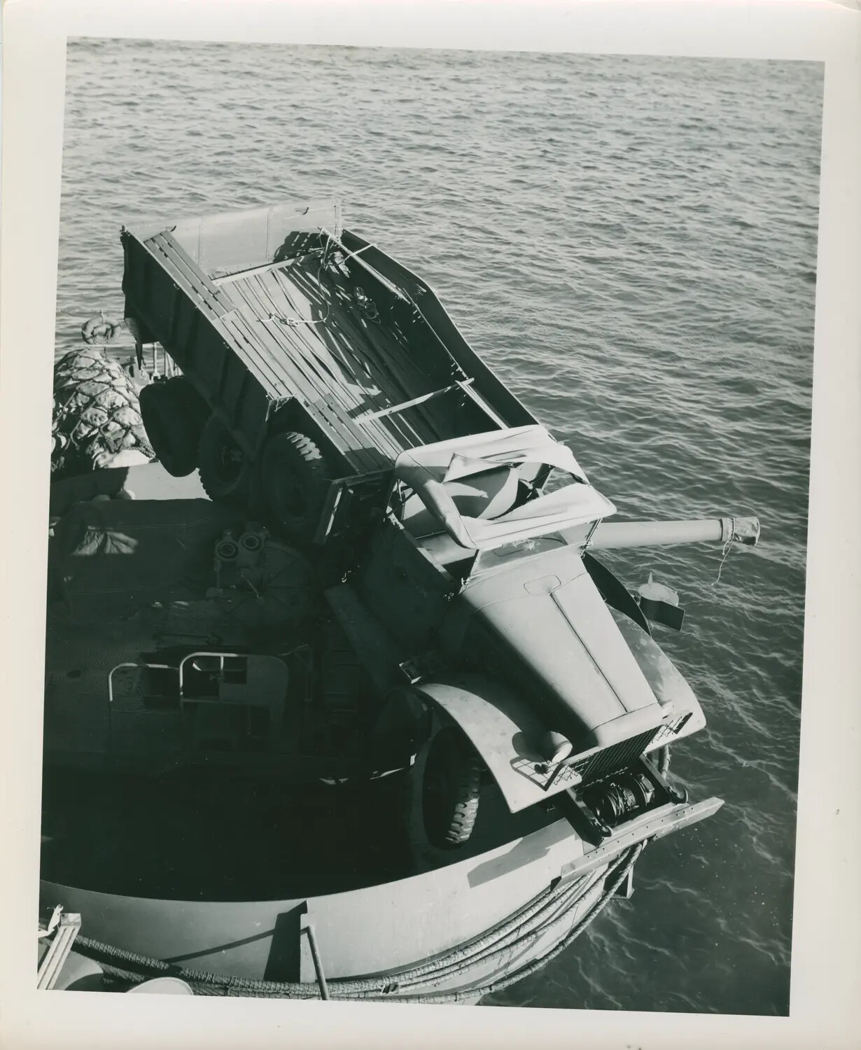 Cargo Truck Loaded Aboard Landing Craft Alongside USS Petrof Bay (CVE-80)