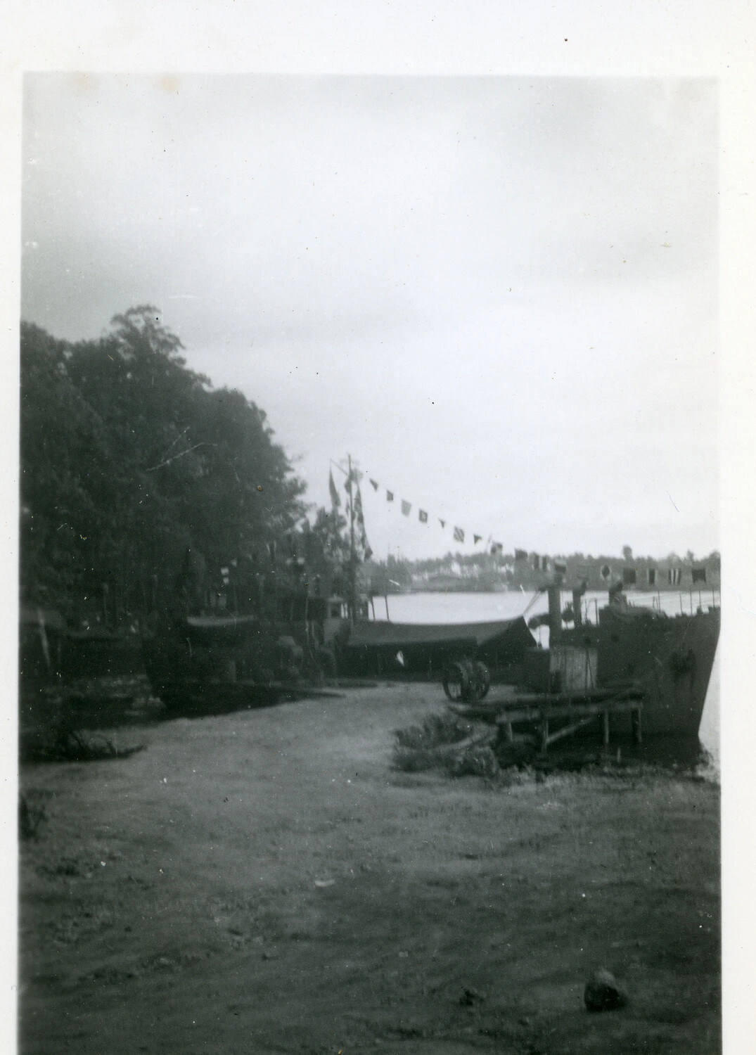 Small Naval Craft Dressed with Signal Flags at a Pacific Shore Base