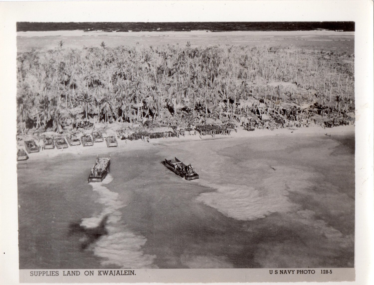 "Supplies Land on Kwajalein" - U.S. Navy Official Photograph 128-5, Marshall Islands Campaign, 1944