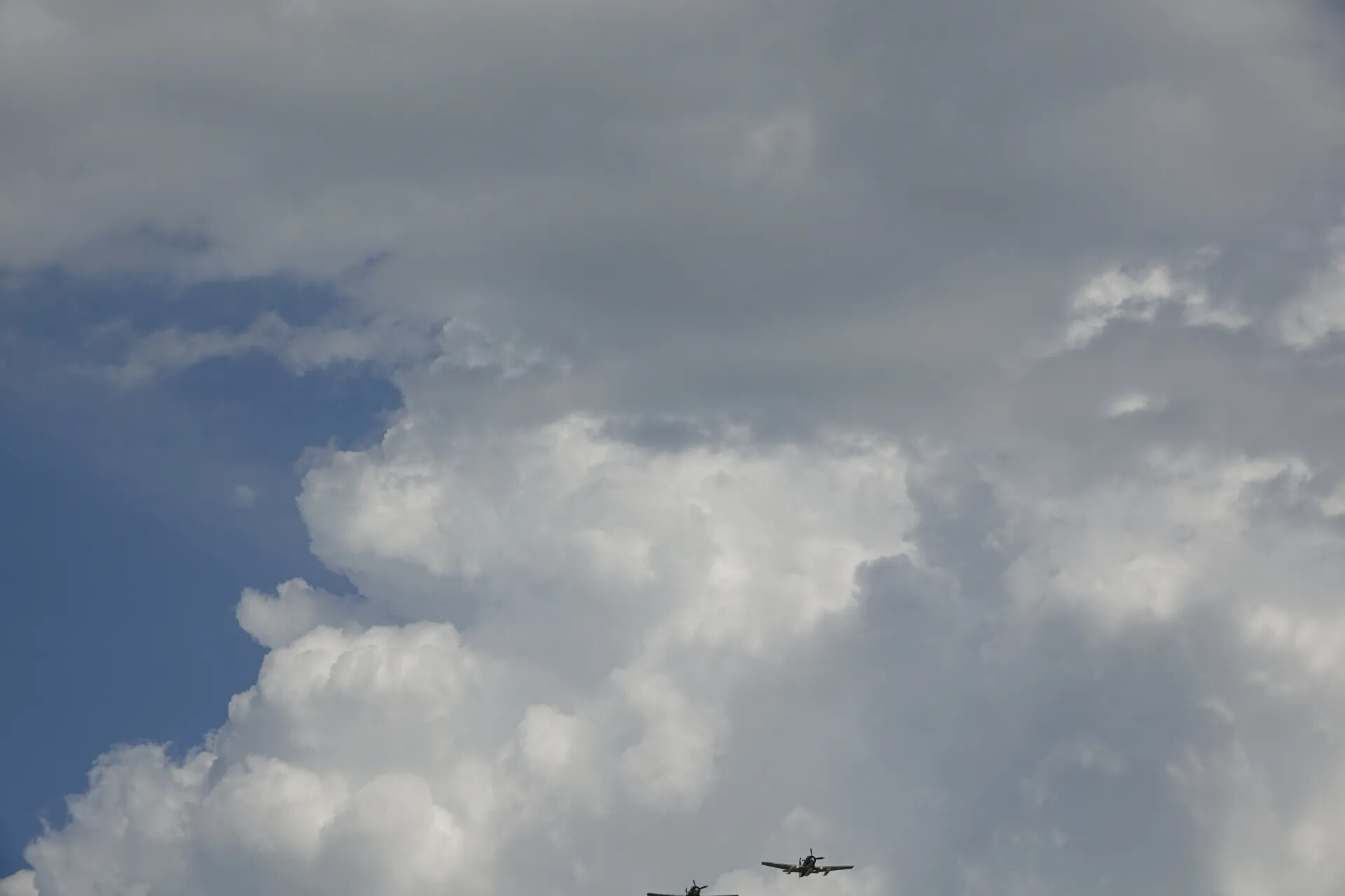 Two Aircraft in Formation Flight Beneath Cumulus Clouds, May 2019 Air Event