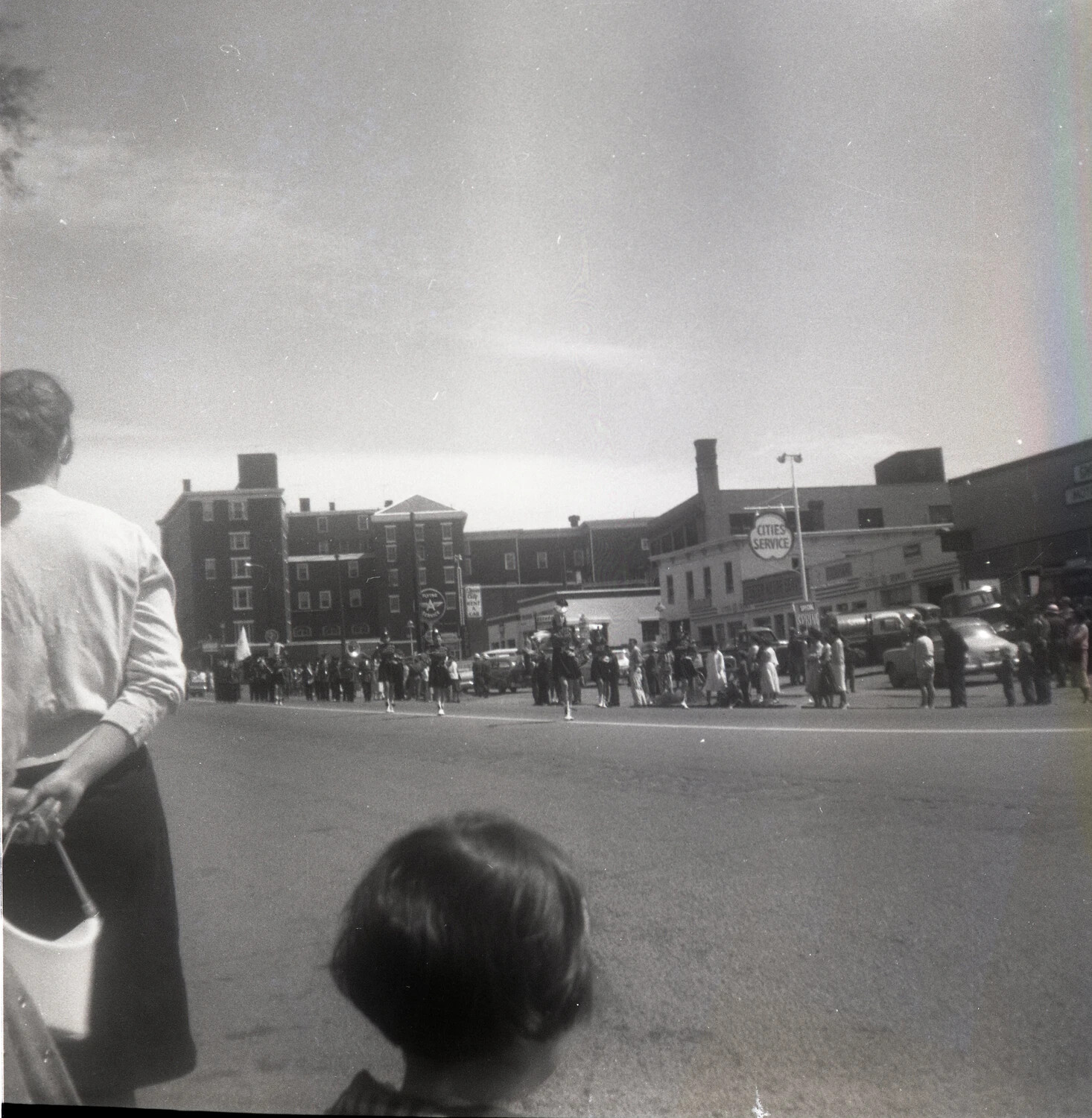 Downtown Parade with Marching Band and Cities Service Station - Mid-Century American Main Street