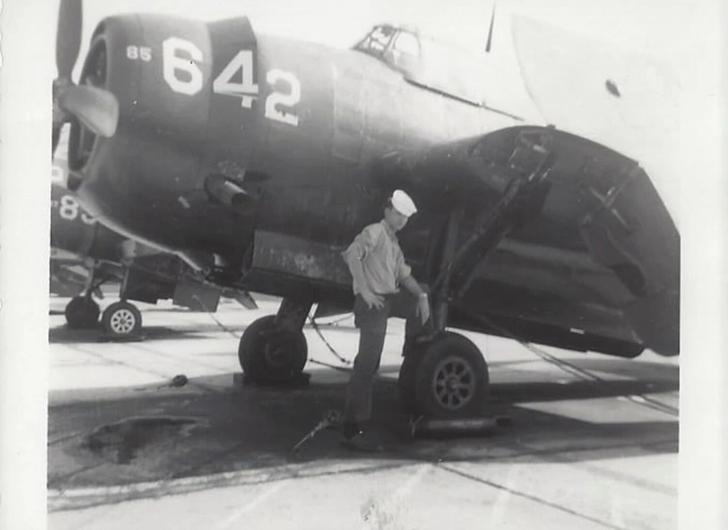 Sailor with Folded-Wing F4U Corsair Fighter, NAS Jacksonville