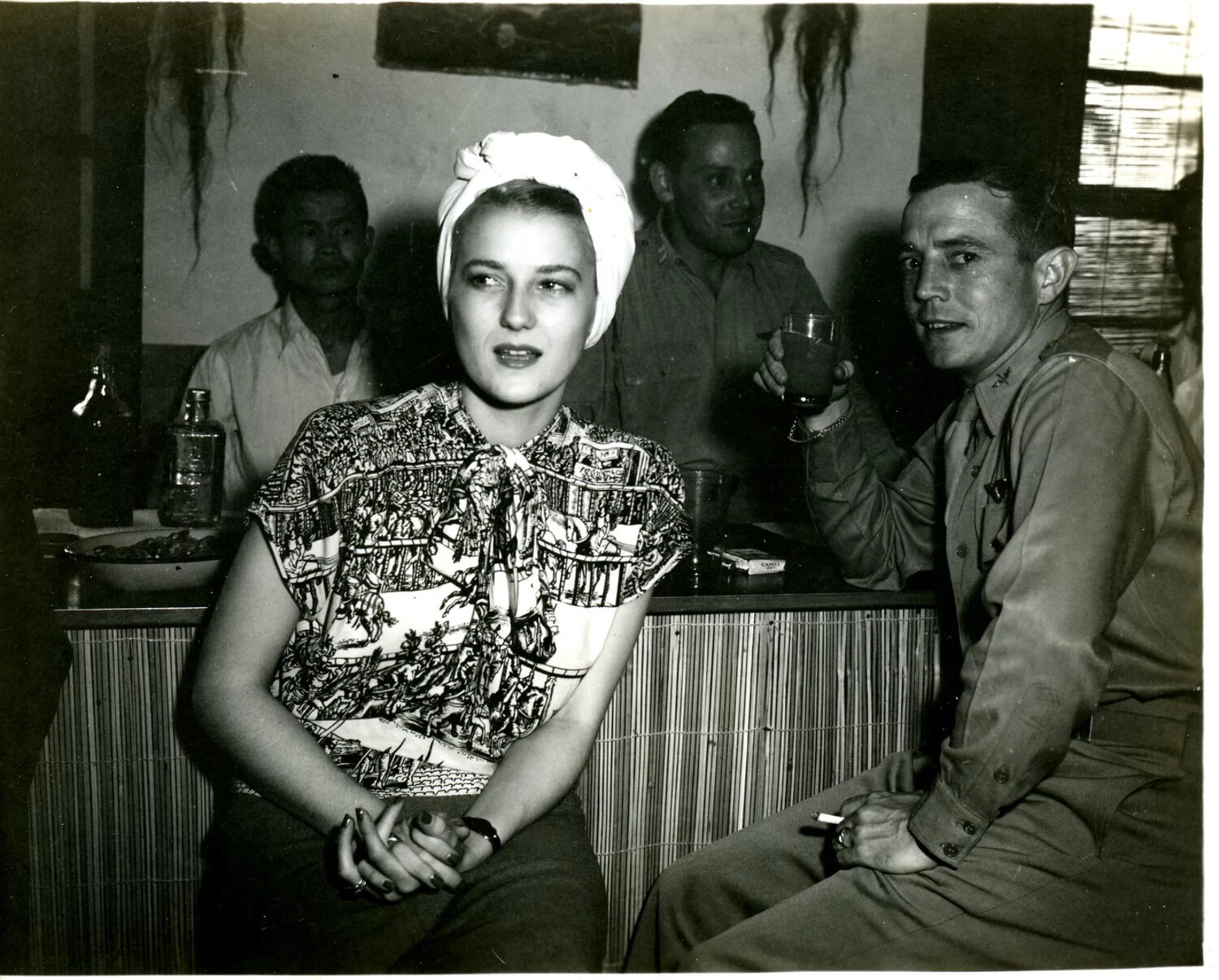 Officers and Civilian Woman at a Bar, China-Burma-India Theater, World War II Era
