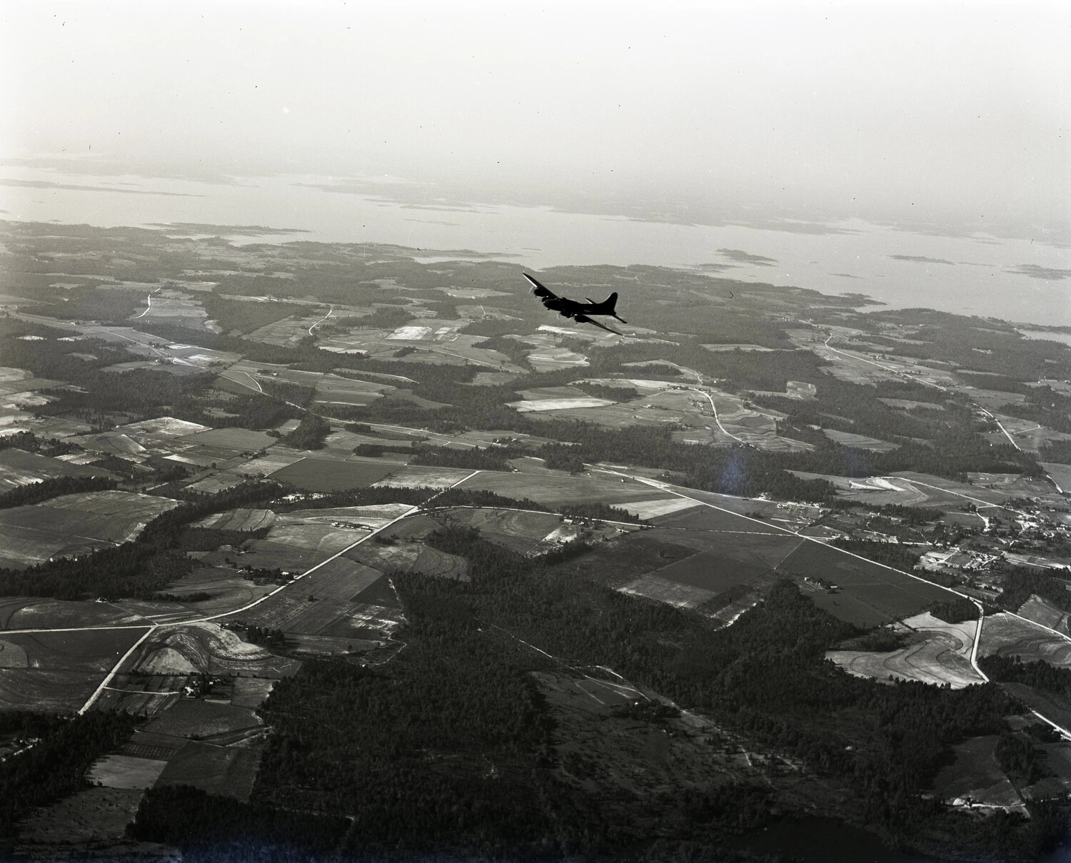 Boeing B-17 Flying Fortress in Flight, Air-to-Air View Over Farmland and Coastline