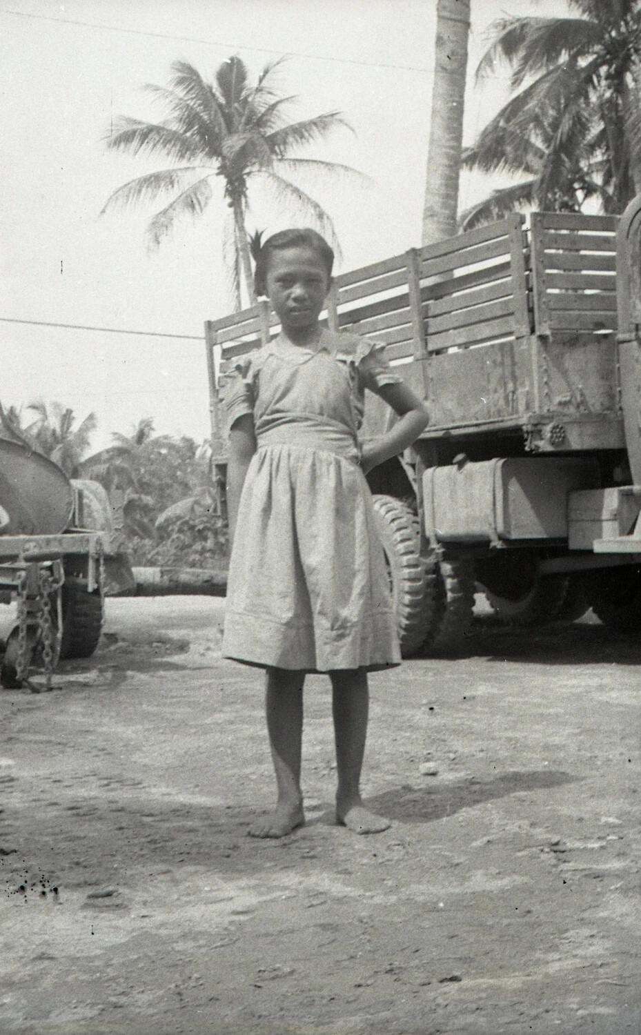 Filipino Girl with U.S. Army Truck, Luzon, Philippines, WWII Era