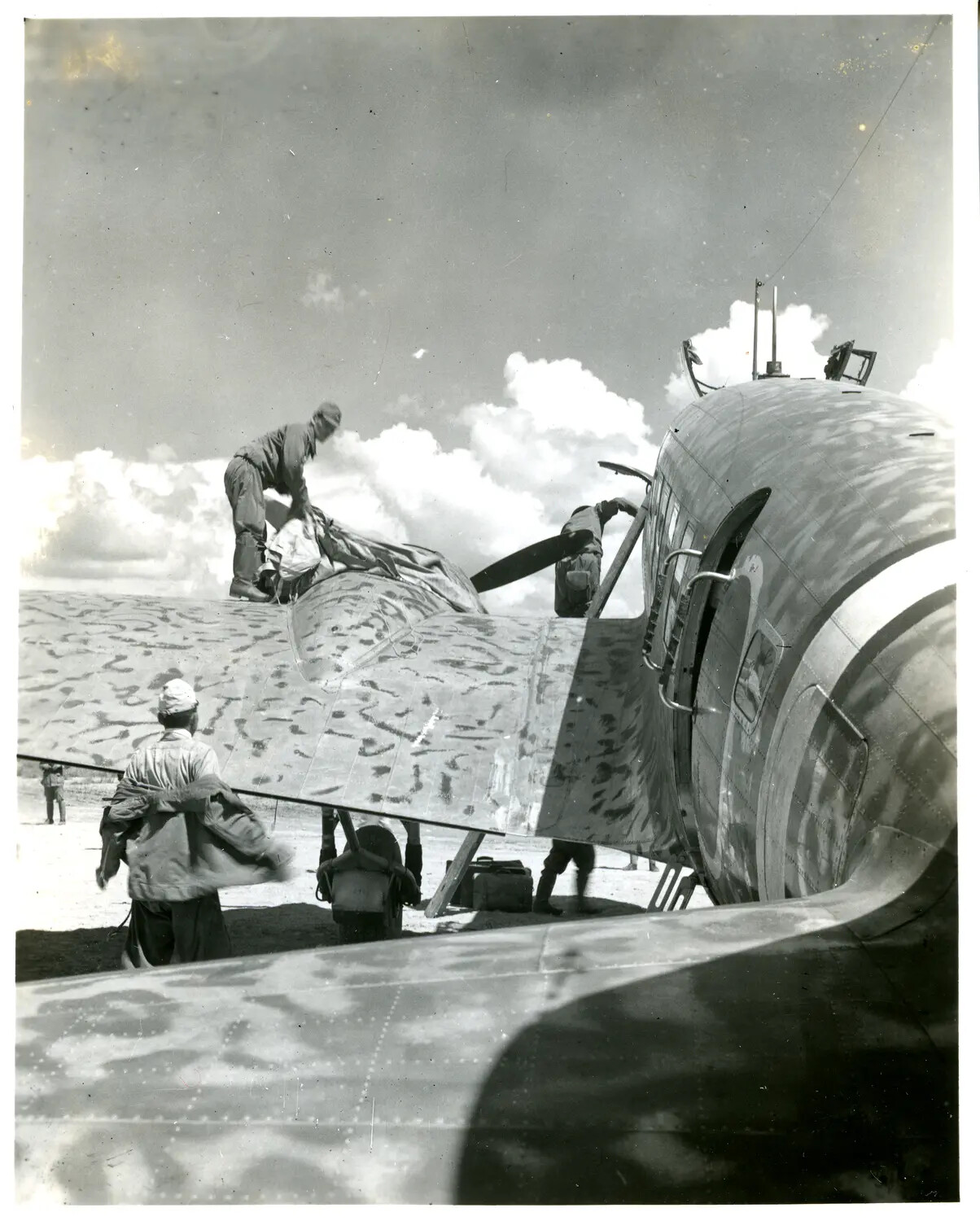 Ground Crew Servicing a Camouflaged Transport Aircraft, CBI Theater