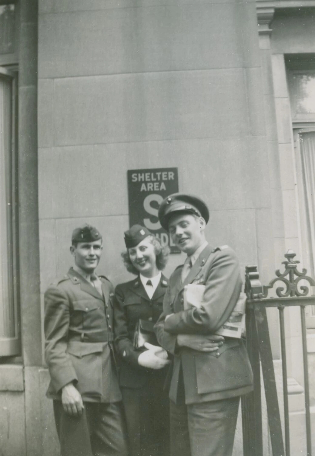 Three U.S. Servicemembers Posing by a Wartime Air Raid Shelter Sign, WWII