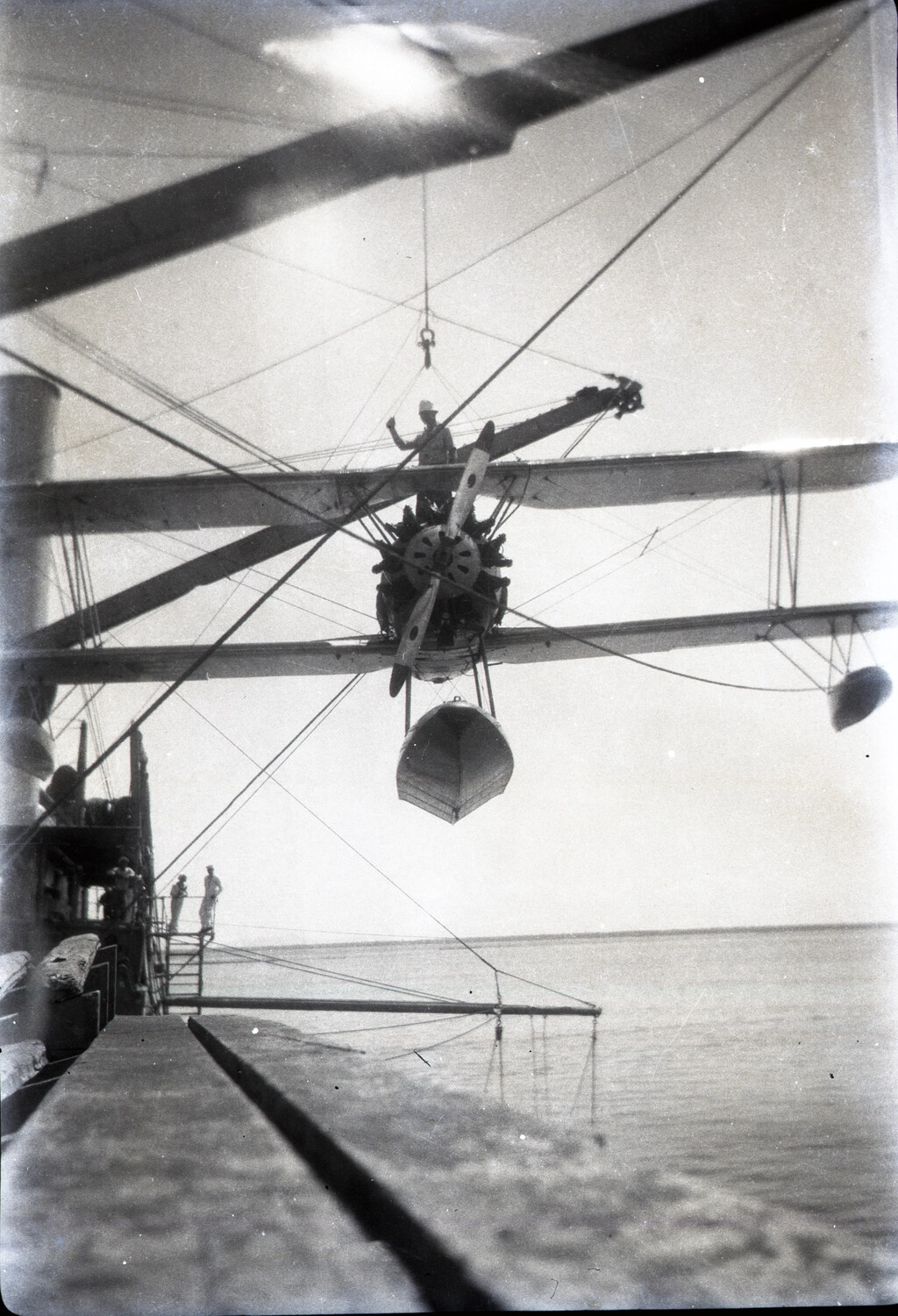 U.S. Navy Scout Floatplane Being Hoisted Aboard Warship, China/Pacific Station, 1930s