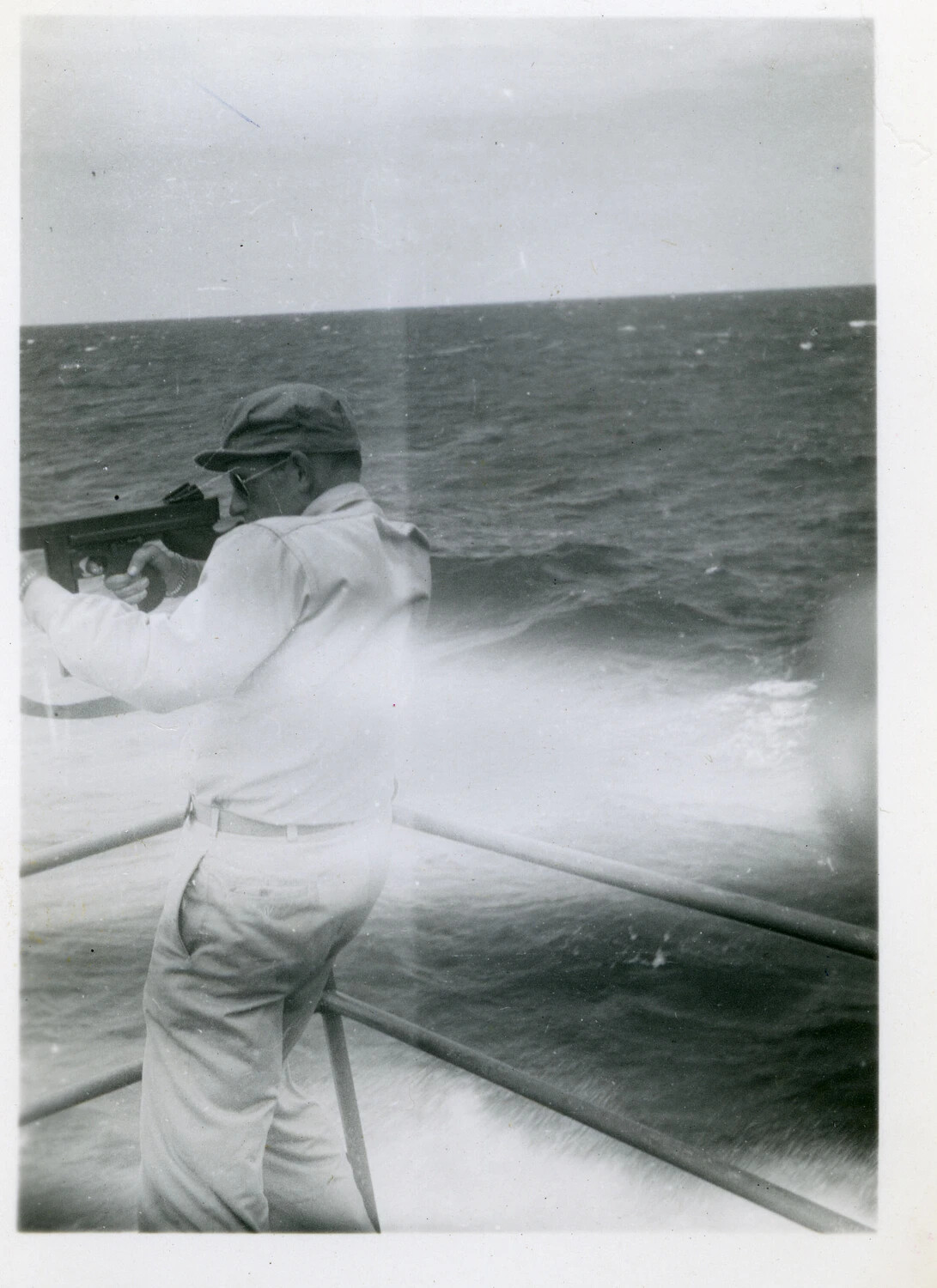 Sailor Firing a Thompson Submachine Gun from the Rail in Heavy Seas, Pacific Theater, World War II