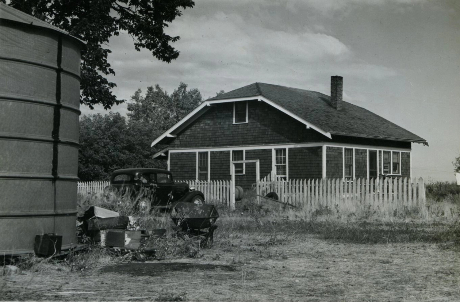 Bancroft Family Residence — Rural Bungalow with Water Tank and Vintage Automobile