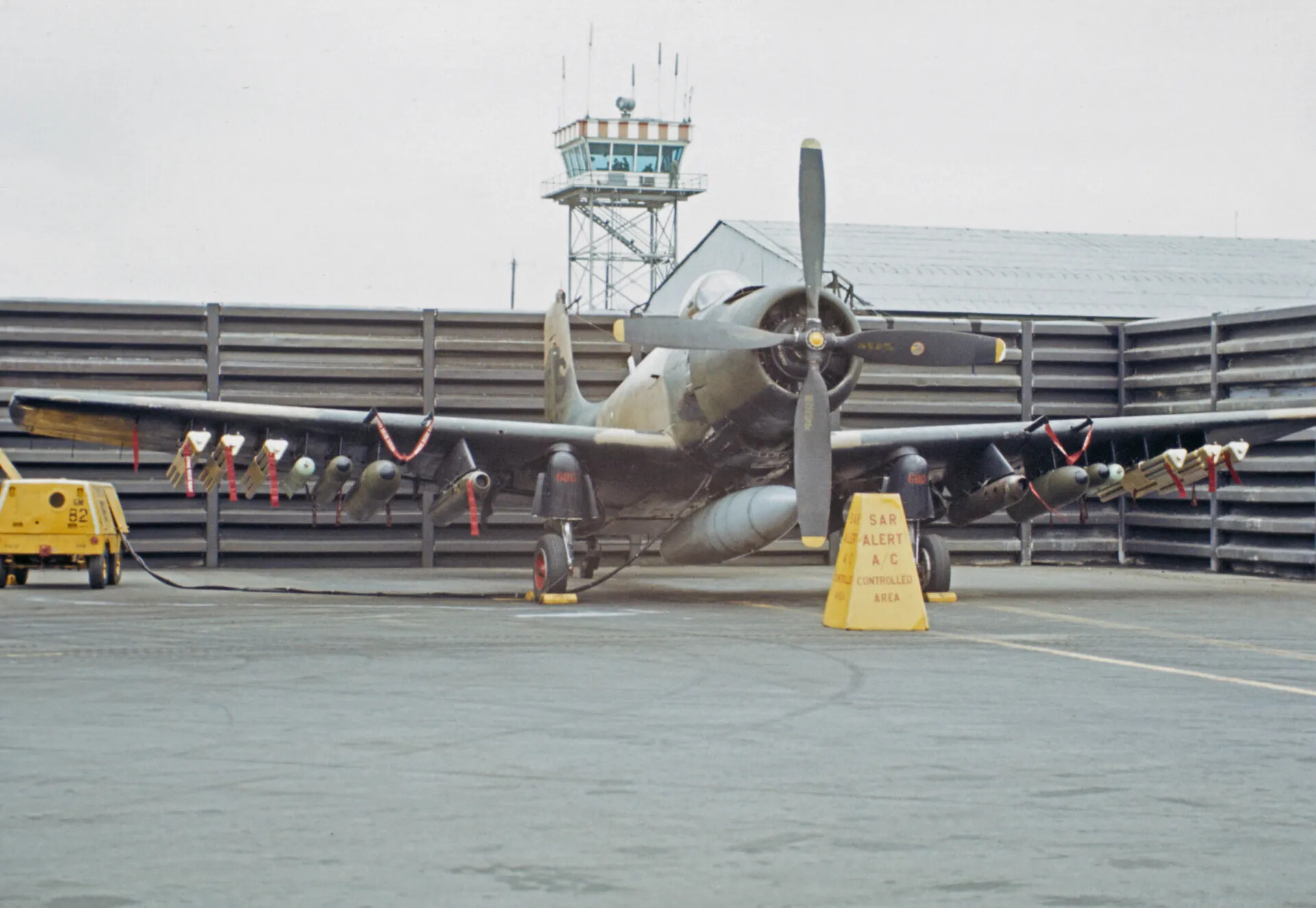 Douglas A-1 Skyraider on SAR Alert Status with Airfield Control Tower Backdrop