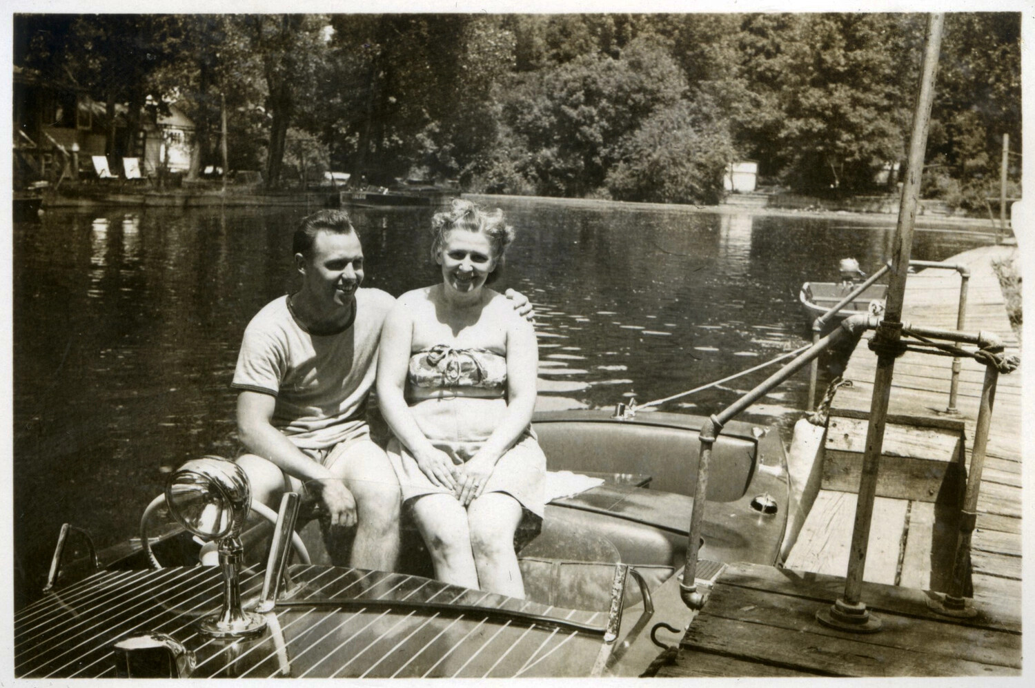 Couple in Wooden Runabout Boat at Lakeside Dock, Bancroft Family Collection