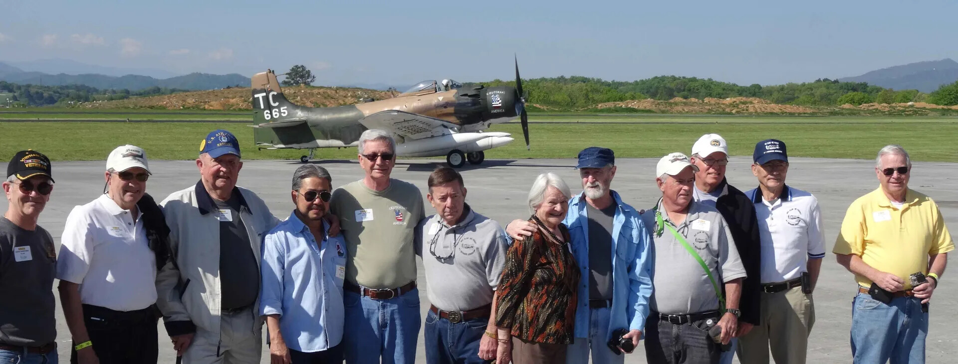 Group Portrait of Veterans and Guests in Front of A-1 Skyraider 'Lieutenant America,' Reunion Event