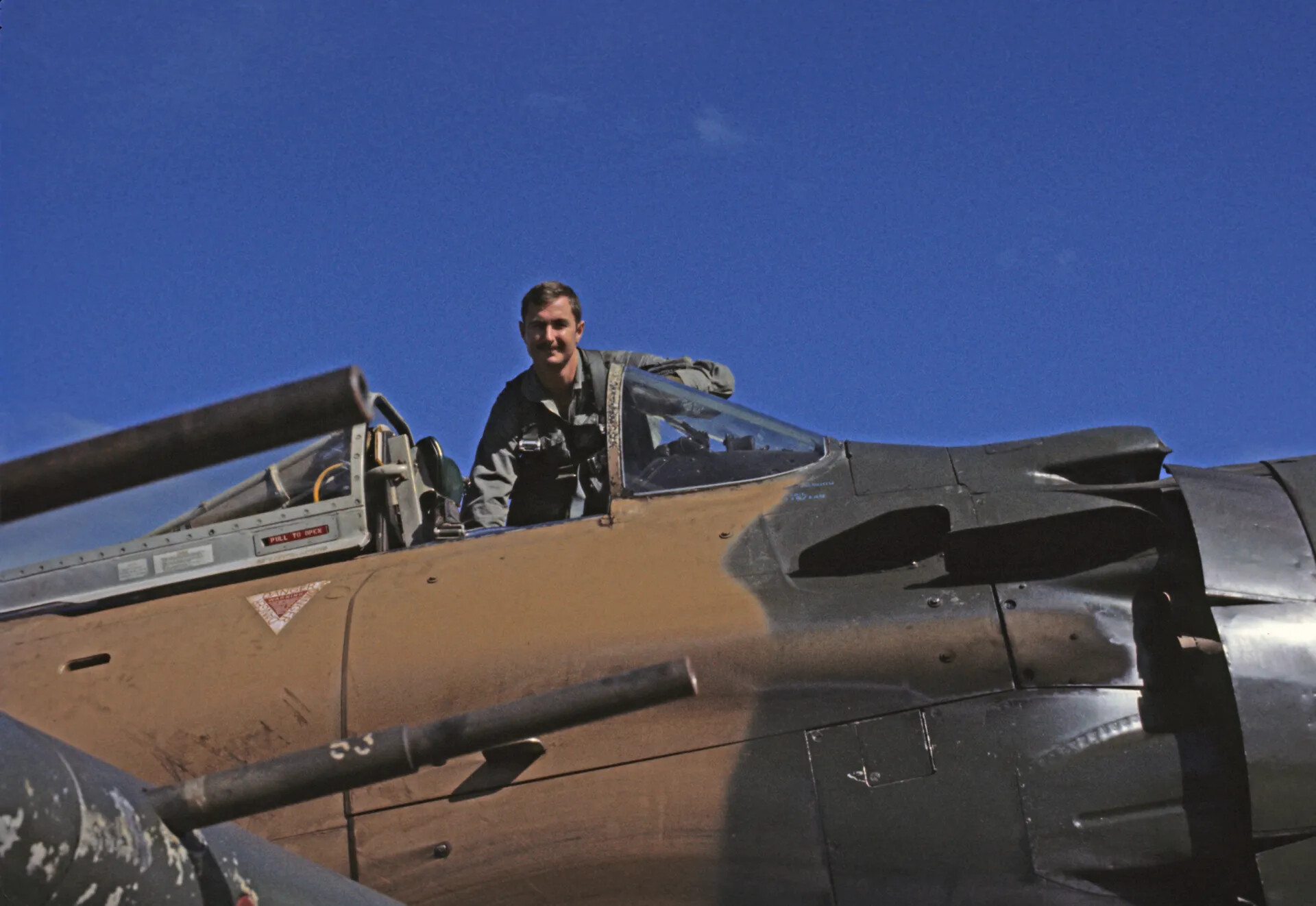 Smiling A-1 Skyraider Pilot Standing in Open Cockpit