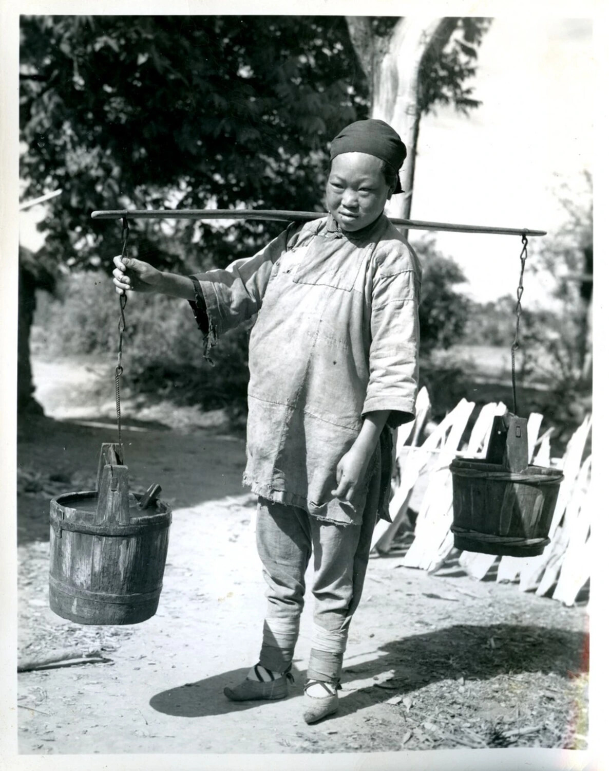 Woman Carrying Water Buckets on Shoulder Yoke, Rural China