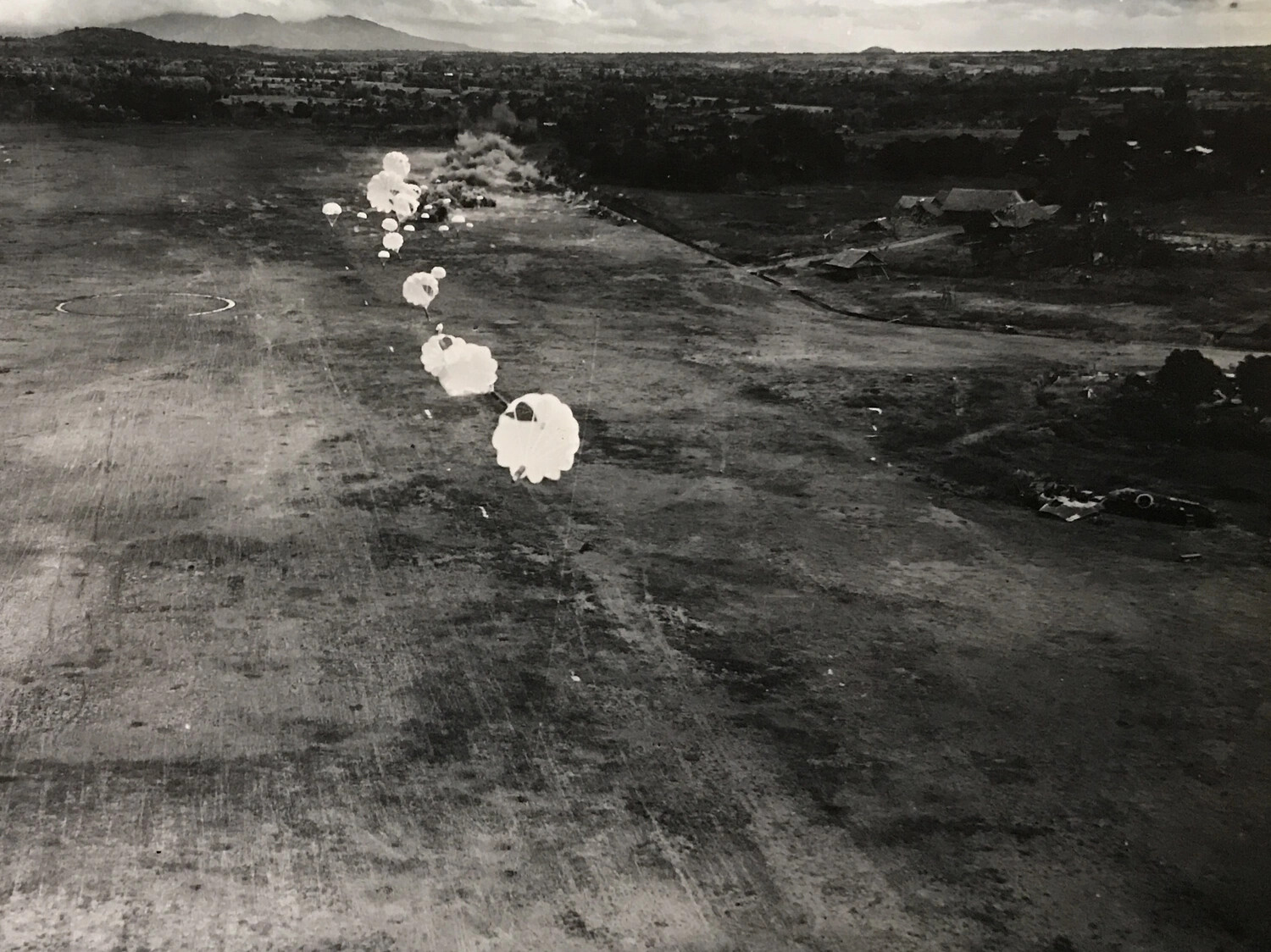 String of Parachute-Fragmentation Bombs Descending on Airfield Target, Pacific Theater