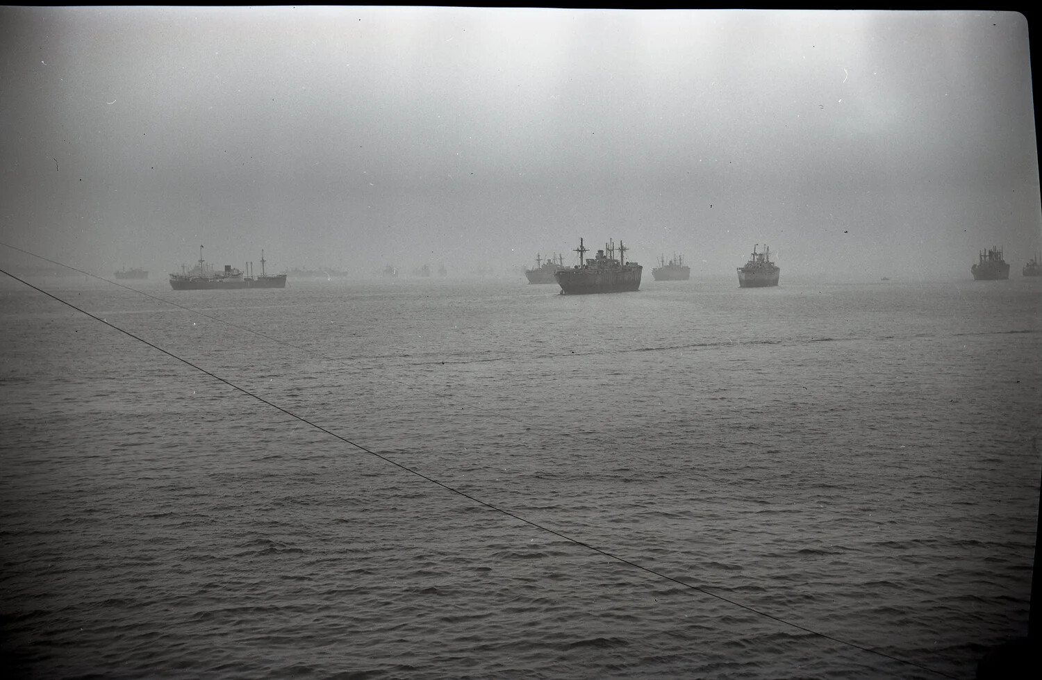 Merchant Ships at Anchor in a Foggy Harbor, Bremerhaven Area, Germany, WWII Era