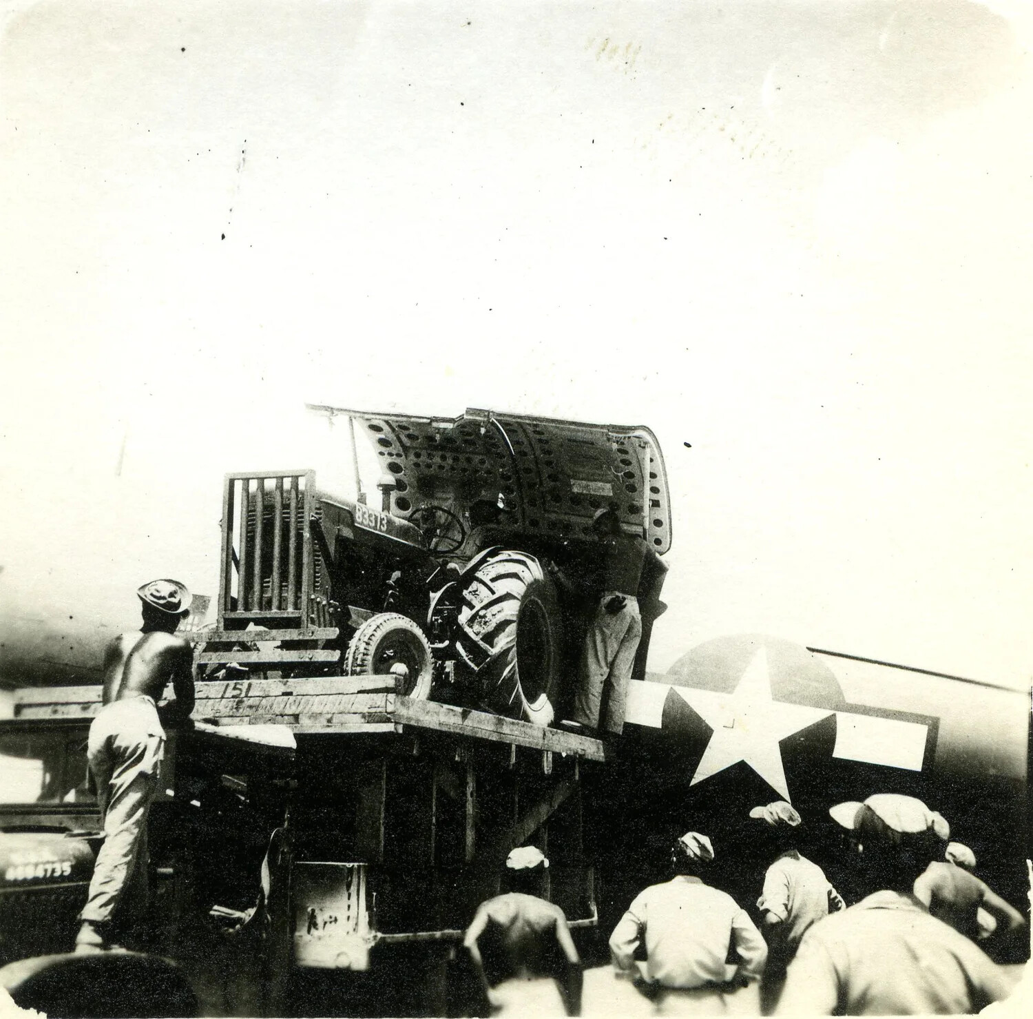 Servicemen Unloading a Tractor Near Parked Aircraft, 345th Bombardment Group Airfield, Pacific Theater, WWII