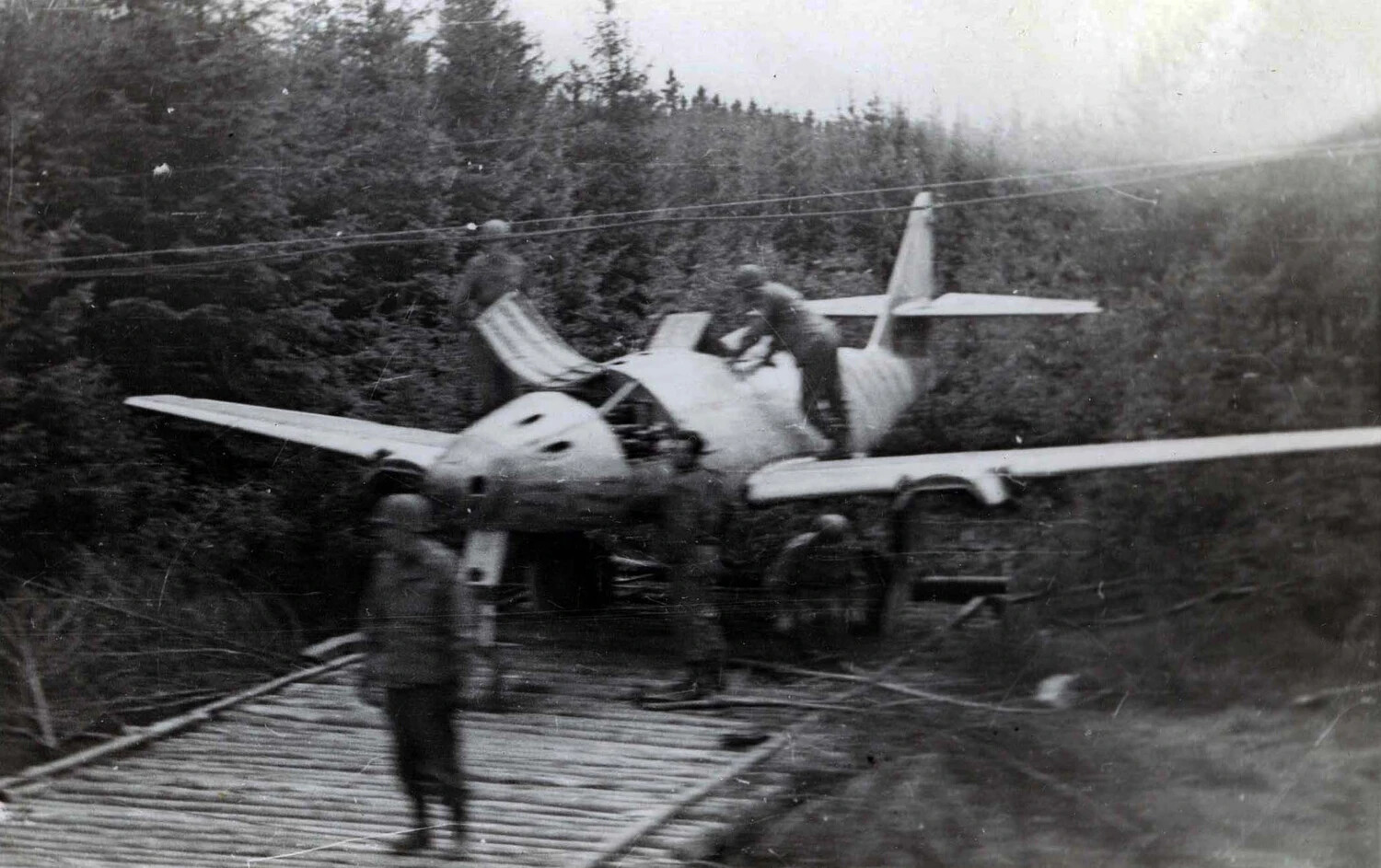 American Soldiers Inspecting Wrecked German Fighter Aircraft on Forest Log Road, WWII European Theater