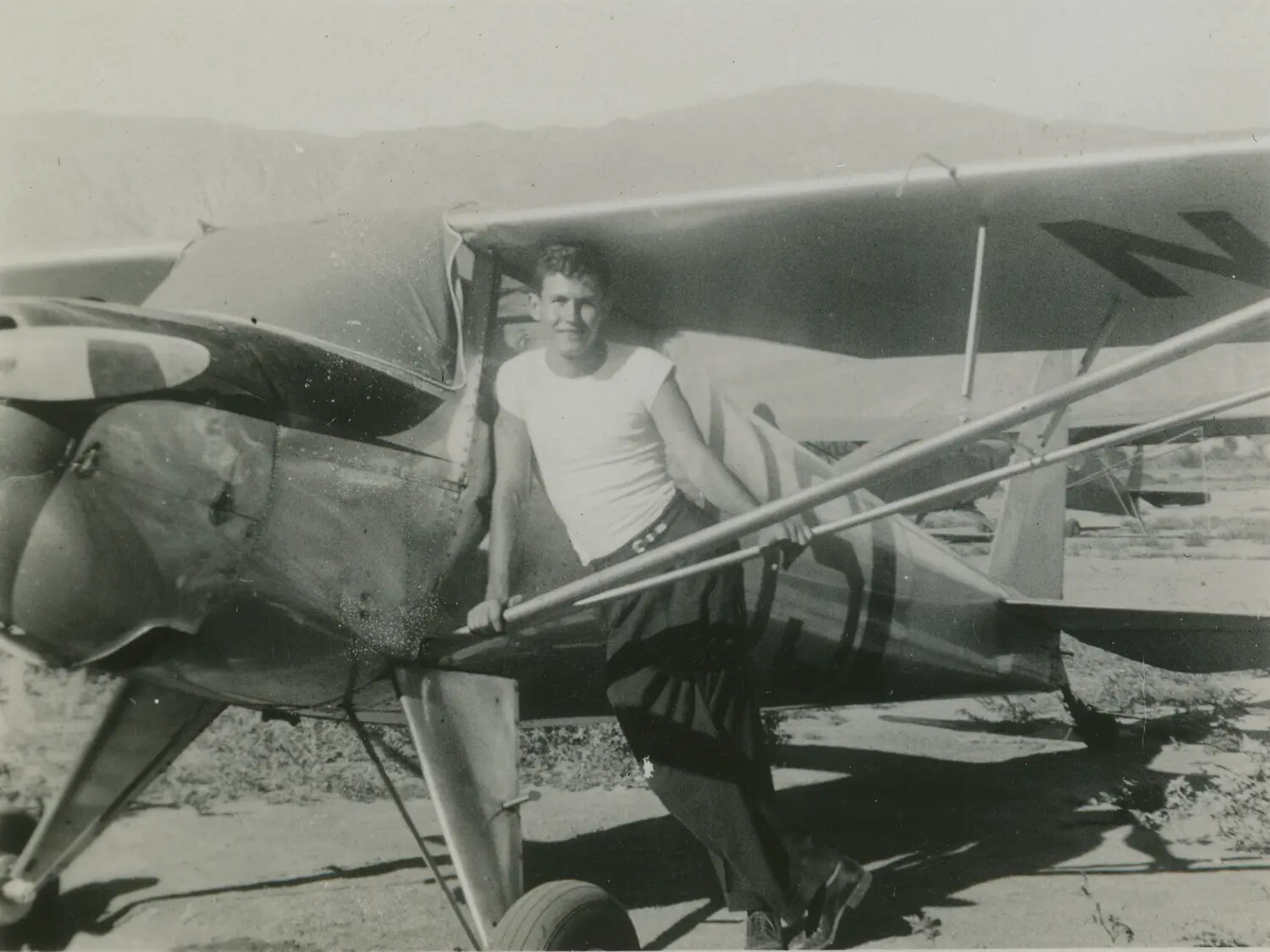 Young Man Posing with Light Civilian Aircraft, McAleer Collection