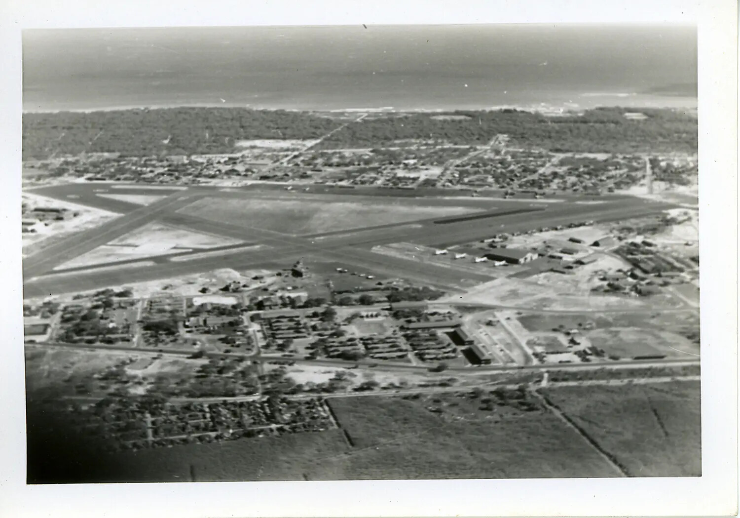 Aerial View of WWII-Era Military Airfield with Crossed Runways, Likely Hawaii (Duplicate/Near-Duplicate Frame)