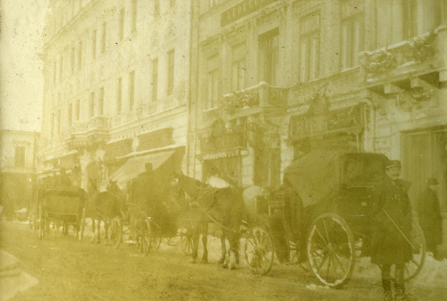 Snow-Dusted European City Street with Horse-Drawn Carriages, WWI Era (French Pilot Album)