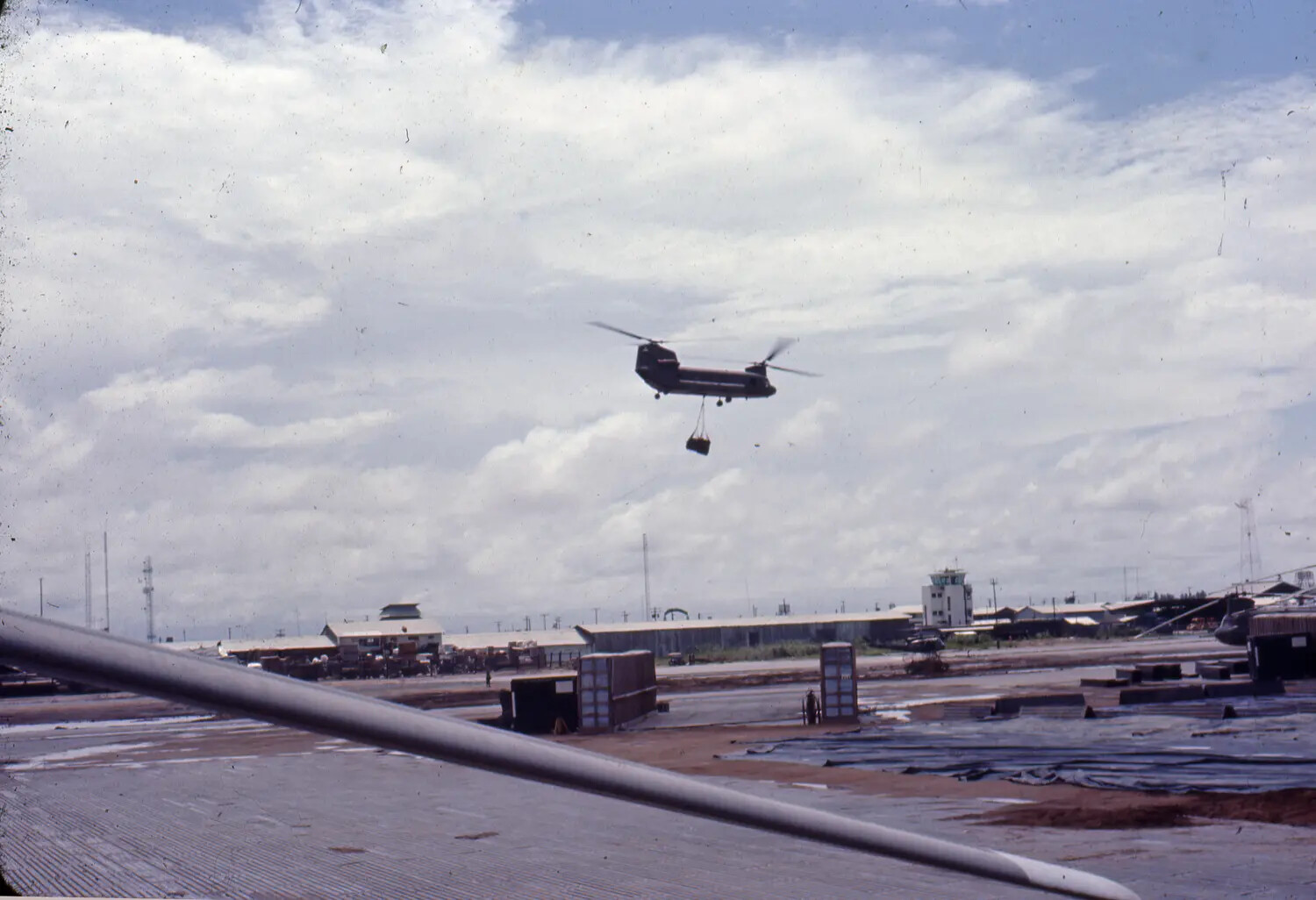 CH-47 Chinook Helicopter Carrying Sling Load Over U.S. Military Airbase, Vietnam War Era