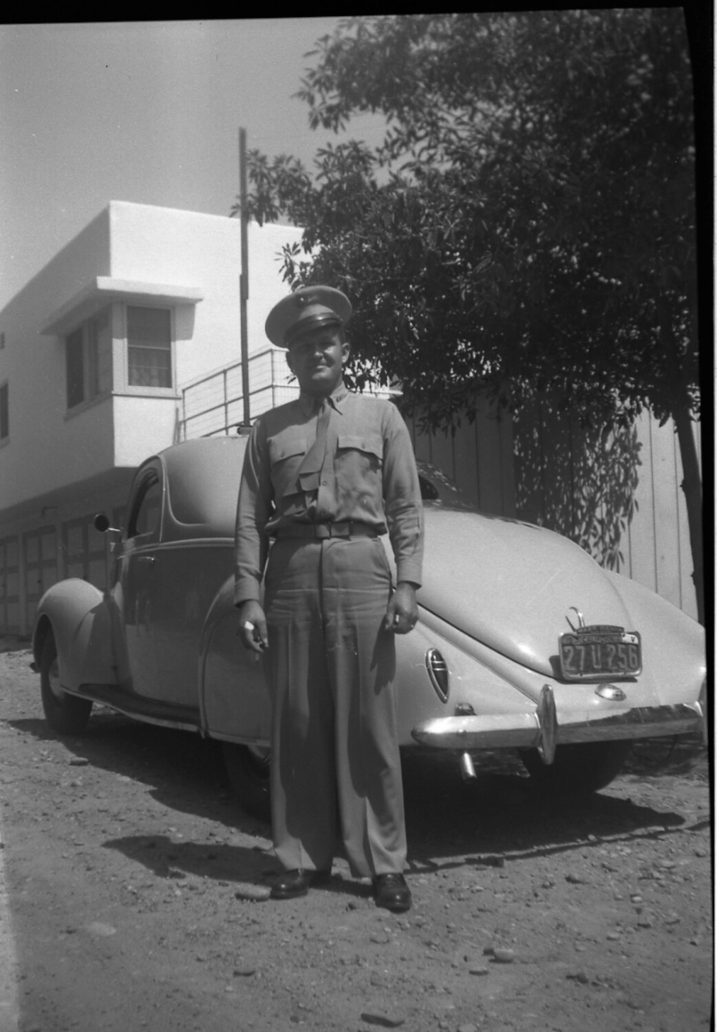 Uniformed Man with Automobile, California, circa 1940-1941