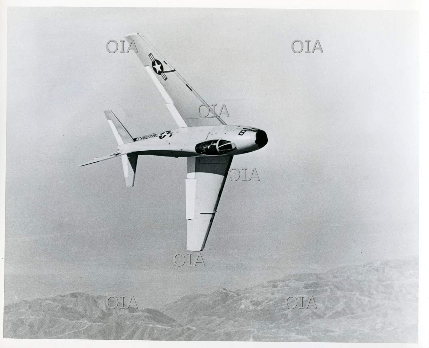 North American FJ-4 Fury in Banking Dive Over Mountainous Terrain