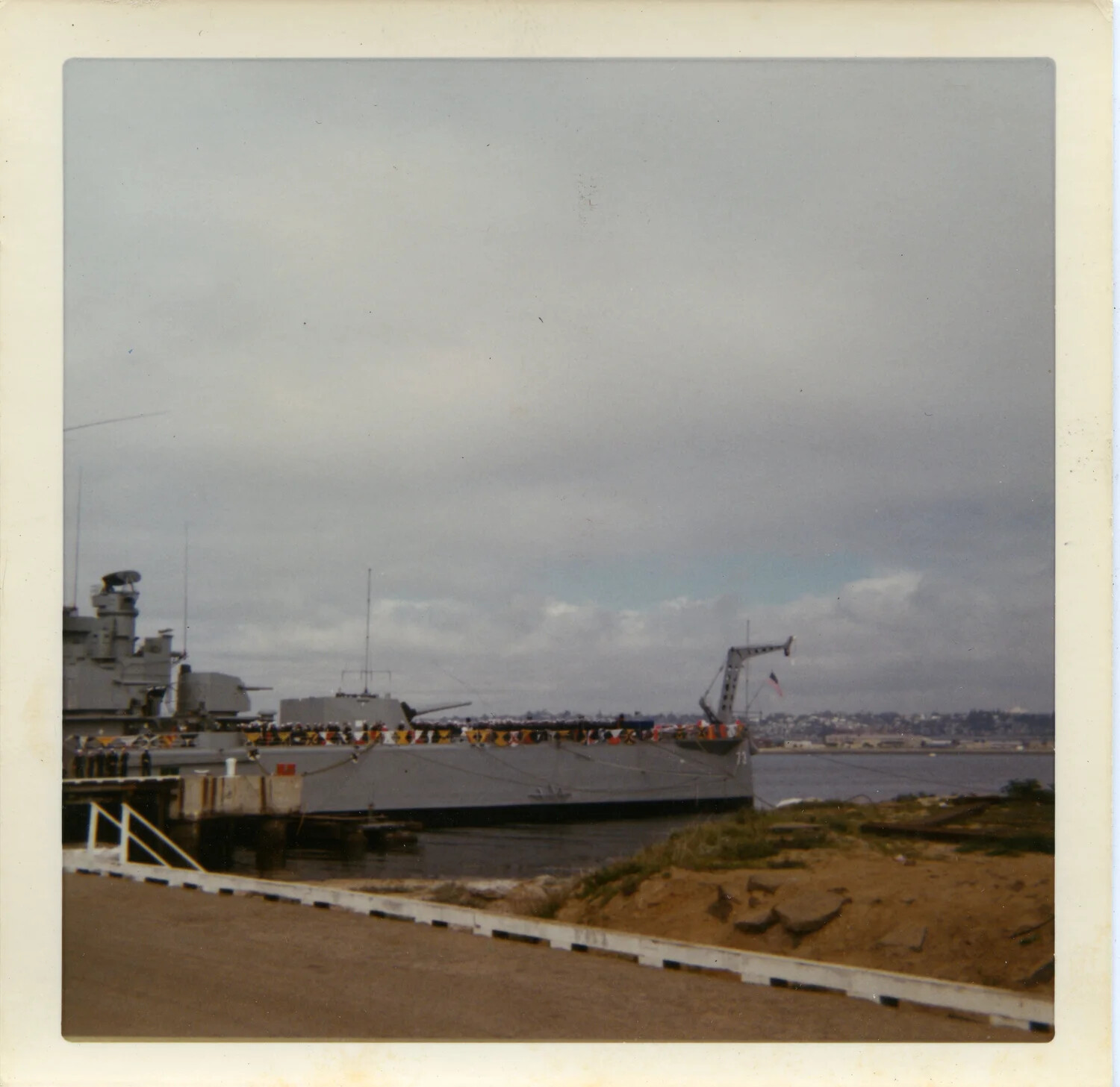 USS Saint Paul (CA-73) Moored Pierside with Crew Manning the Rail, San Diego, circa 1970
