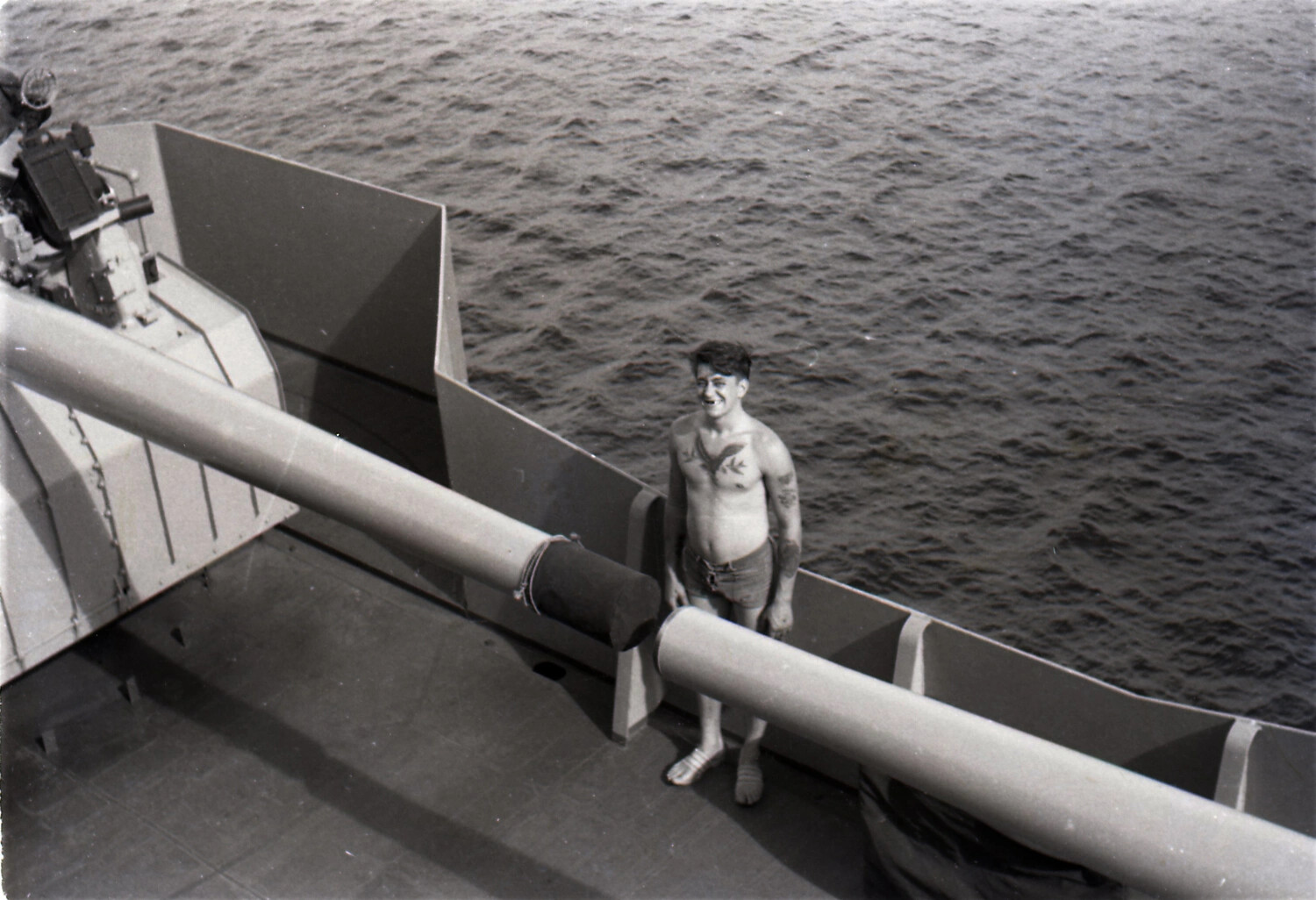 Sailor on Deck Beside Twin Anti-Aircraft Gun Mount, USS Yorktown, c. 1953