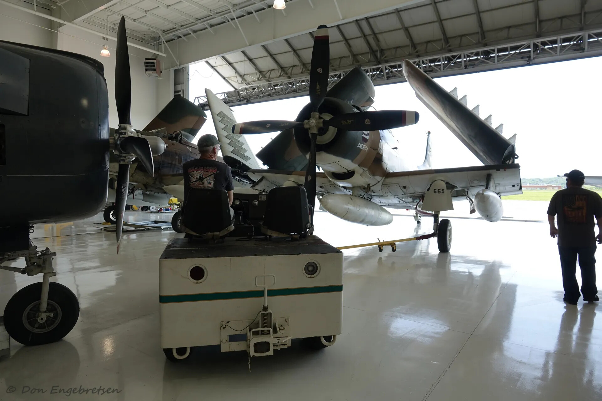 A-1 Skyraider 'Lieutenant America' Being Towed with Wings Folded, Museum Hangar