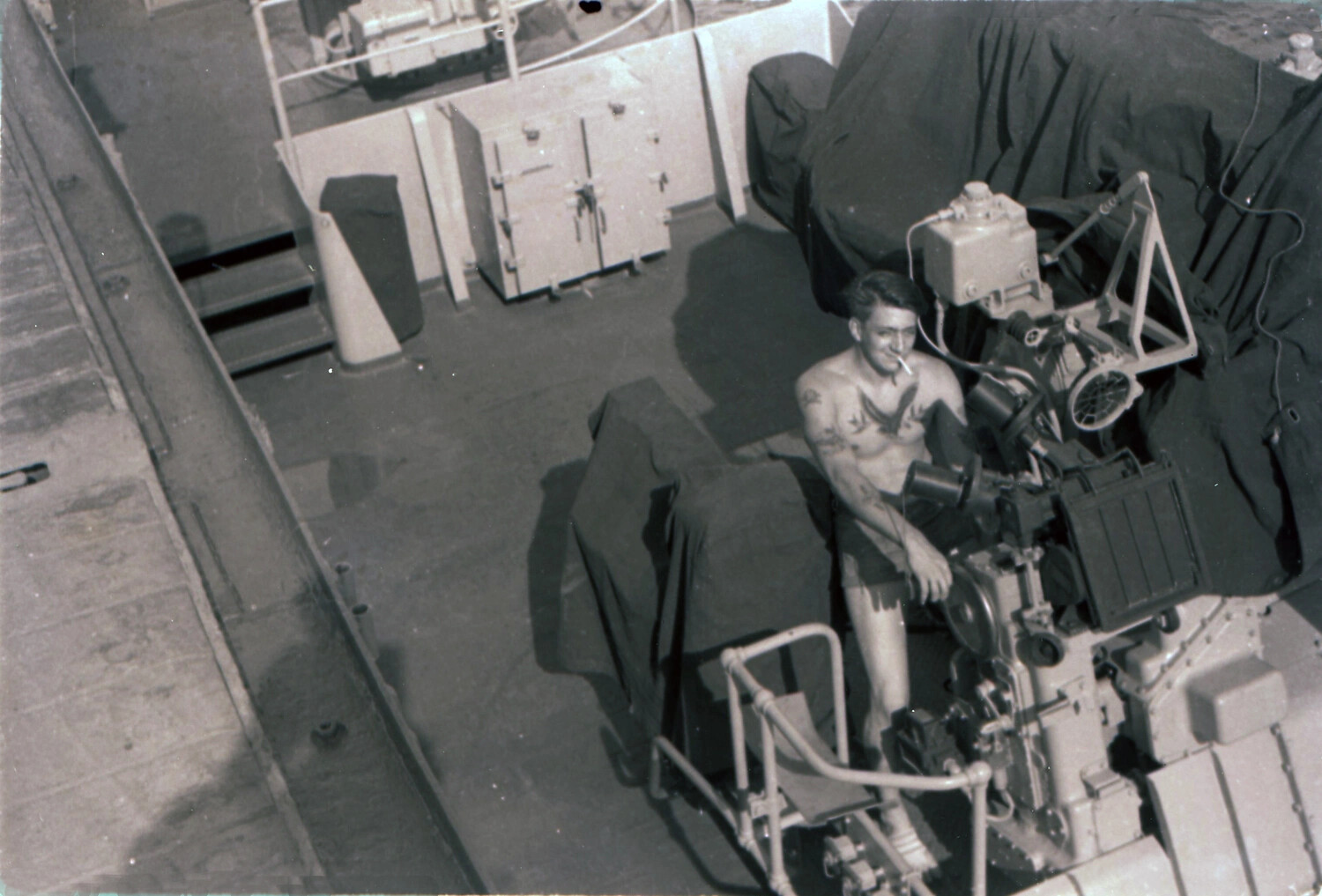 Shirtless Sailor Beside Covered Gun Director Aboard USS Yorktown, 1953