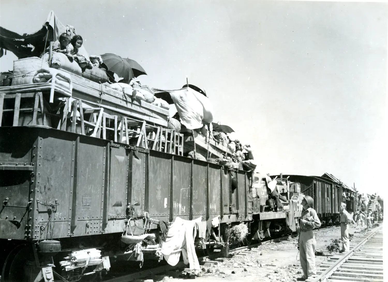 Overloaded Refugee Train with Civilians Riding Atop Freight Cars, China, WWII China-Burma-India Theater