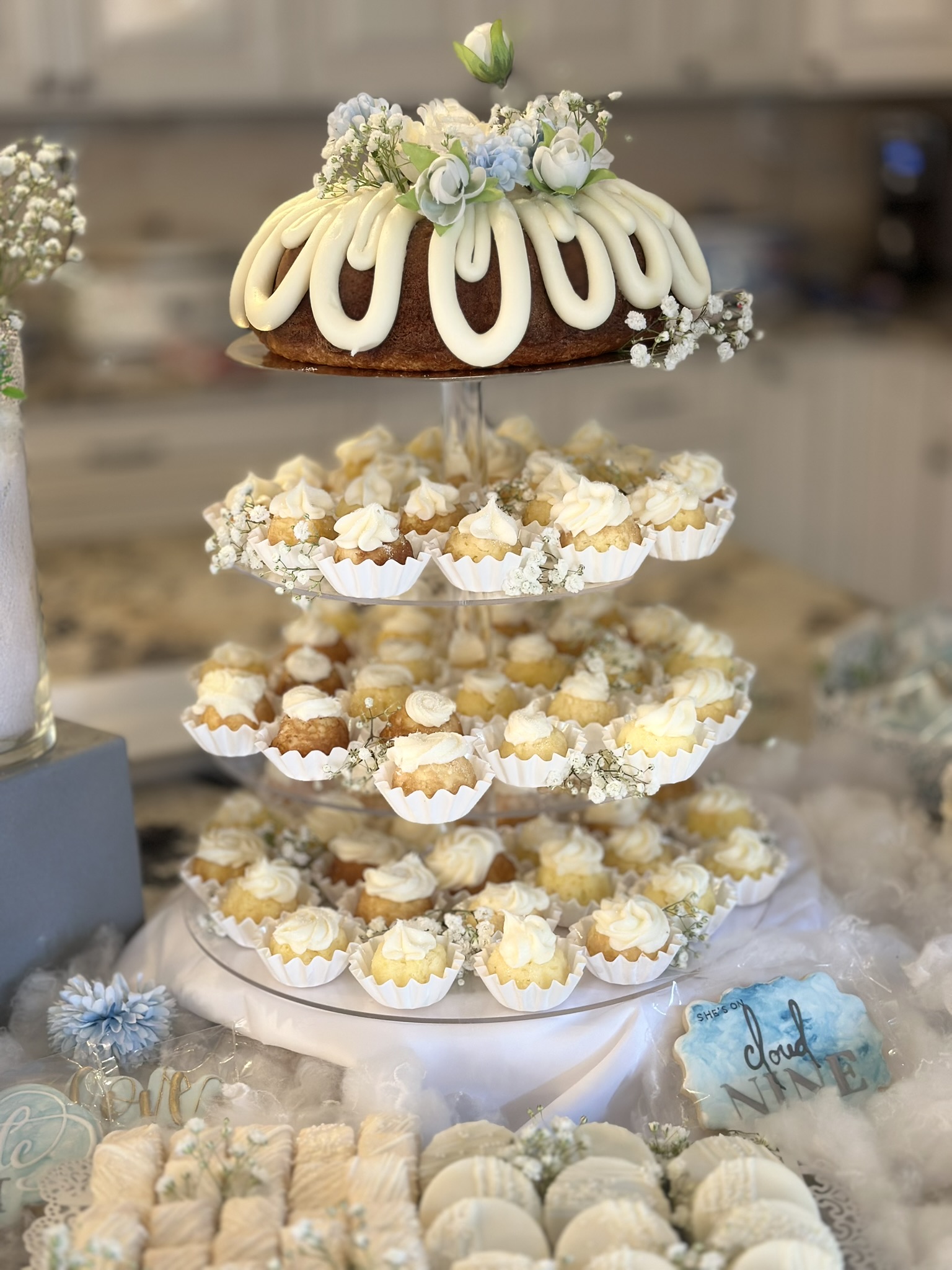Floral bundt cake with white roses, baby's breath, and powder-blue florals.