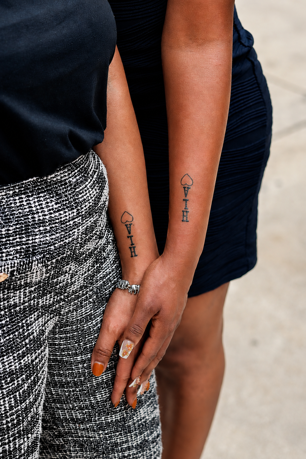 Harryson's sisters showing their HLA tattoos on their wrists