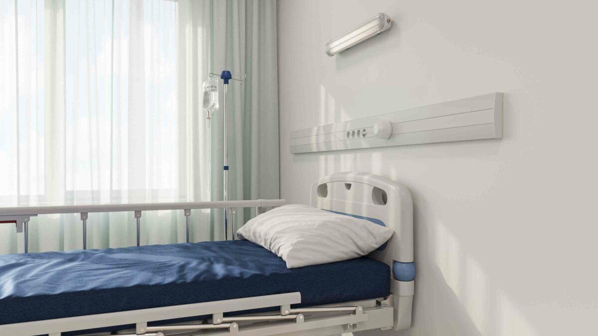 Healthcare professional in a lab coat holding a tablet, symbolizing Remote Patient Monitoring and digital health tracking.