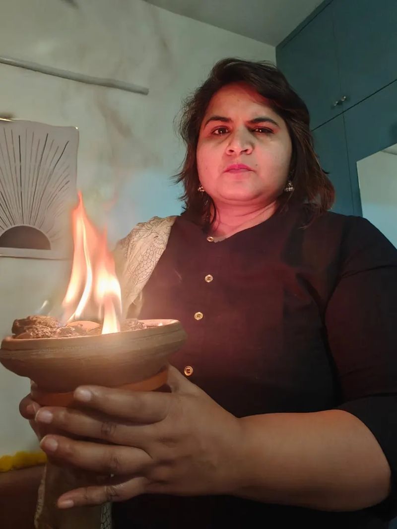 Neha Singla offering a flame to the Mother