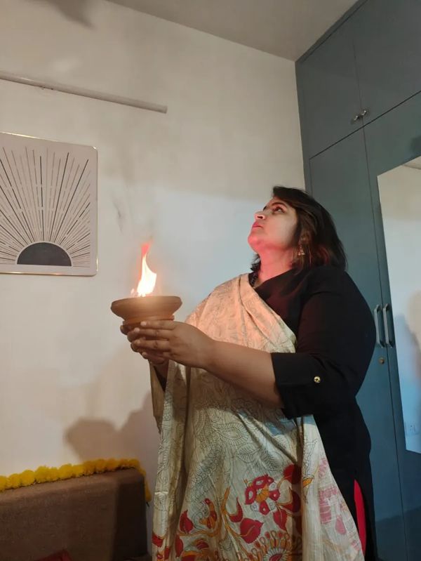 Neha Singla holding a diya