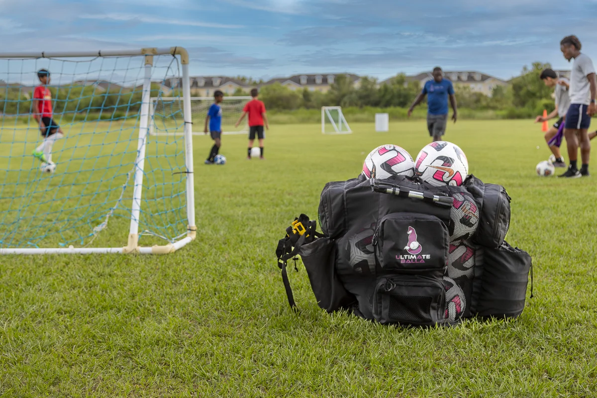Ultimateballa coaching bag beside a soccer training session